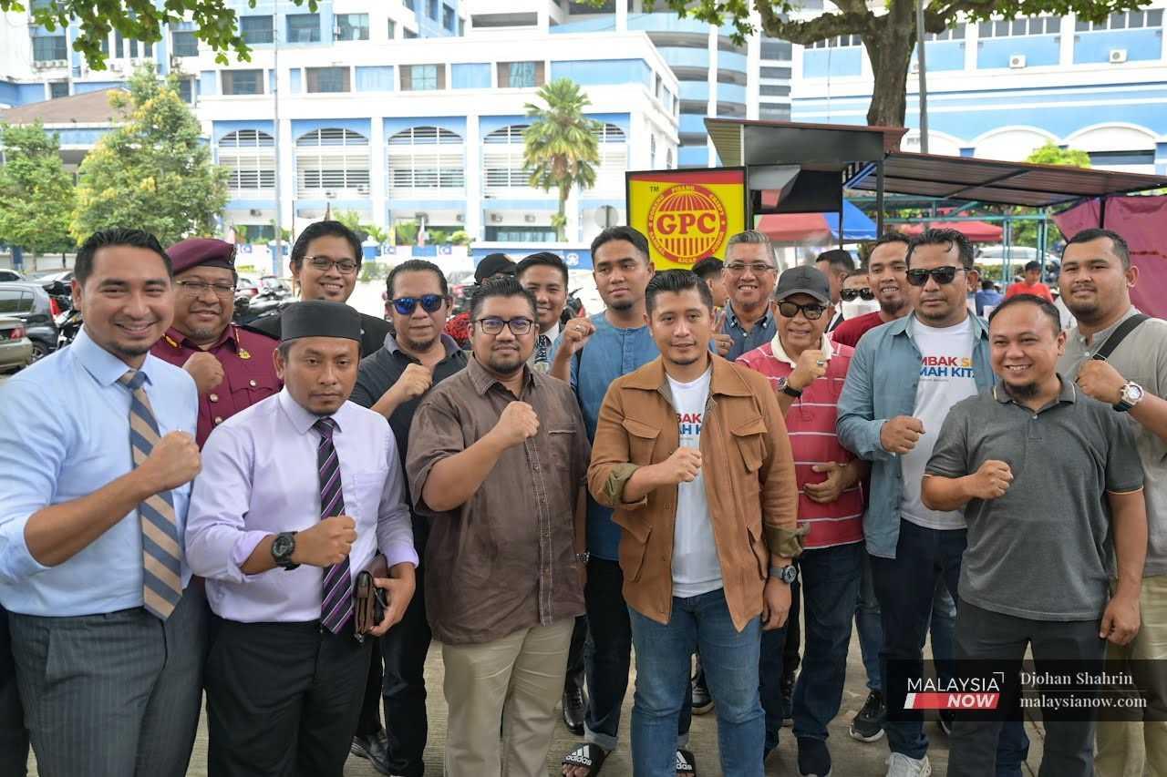 Gombak Setia assemblyman Hilman Idham with Badrul Hisham Shaharin, Machang MP Wan Ahmad Fayshal Wan Ahmad Kamal and other supporters after giving his statement to the police about the 'Save Malaysia' rally at the Dang Wangi police headquarters in Kuala Lumpur.  
