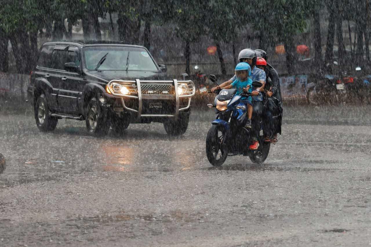 Four people including children ride on a motorcycle during downpour in Dhaka, Bangladesh, Sept 11. Photo: Reuters