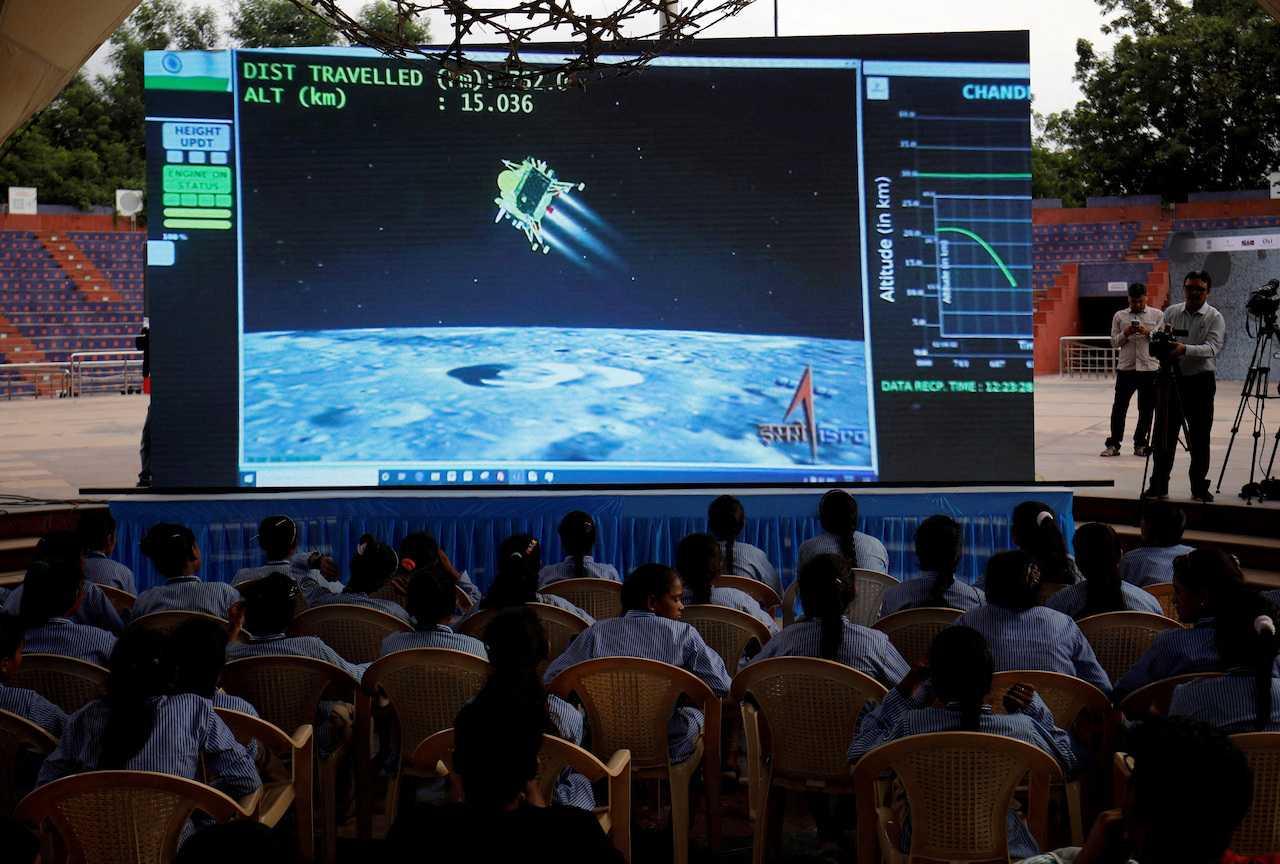 People watch a live stream of Chandrayaan-3 spacecraft's landing on the moon, inside an auditorium of Gujarat Science City in Ahmedabad, India, Aug 23. Photo: Reuters