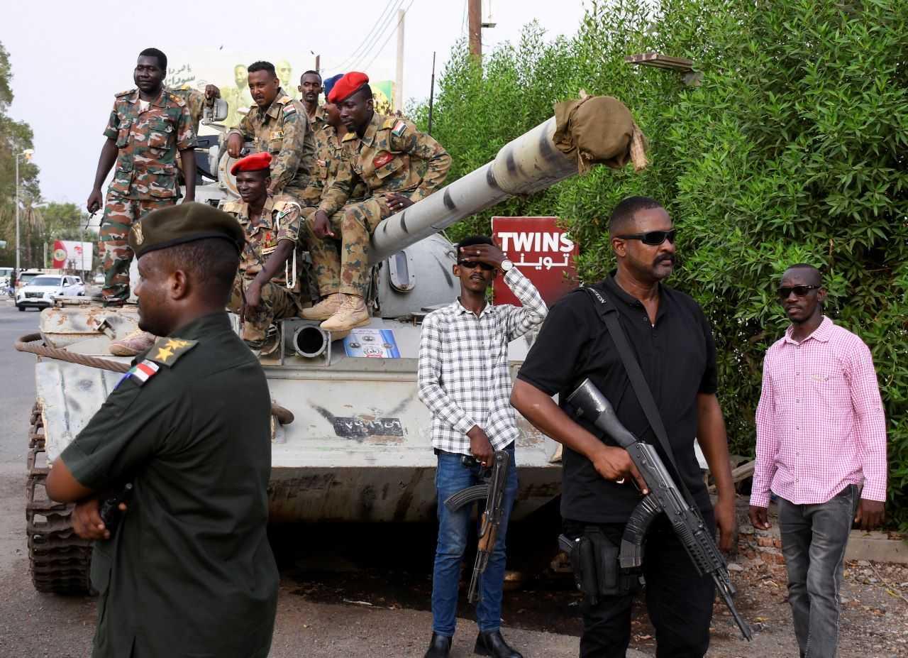 Members of military armed guard and members in plainclothes are seen around a tank after the arrival of Sudan's General Abdel Fattah al-Burhan in the military airport in the city of Port Sudan, Sudan, Aug 27. Photo: Reuters