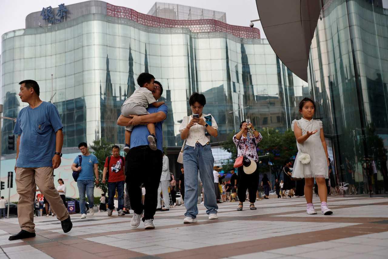 People walk at a shopping area in Beijing, China, Sept 5. Photo: Reuters