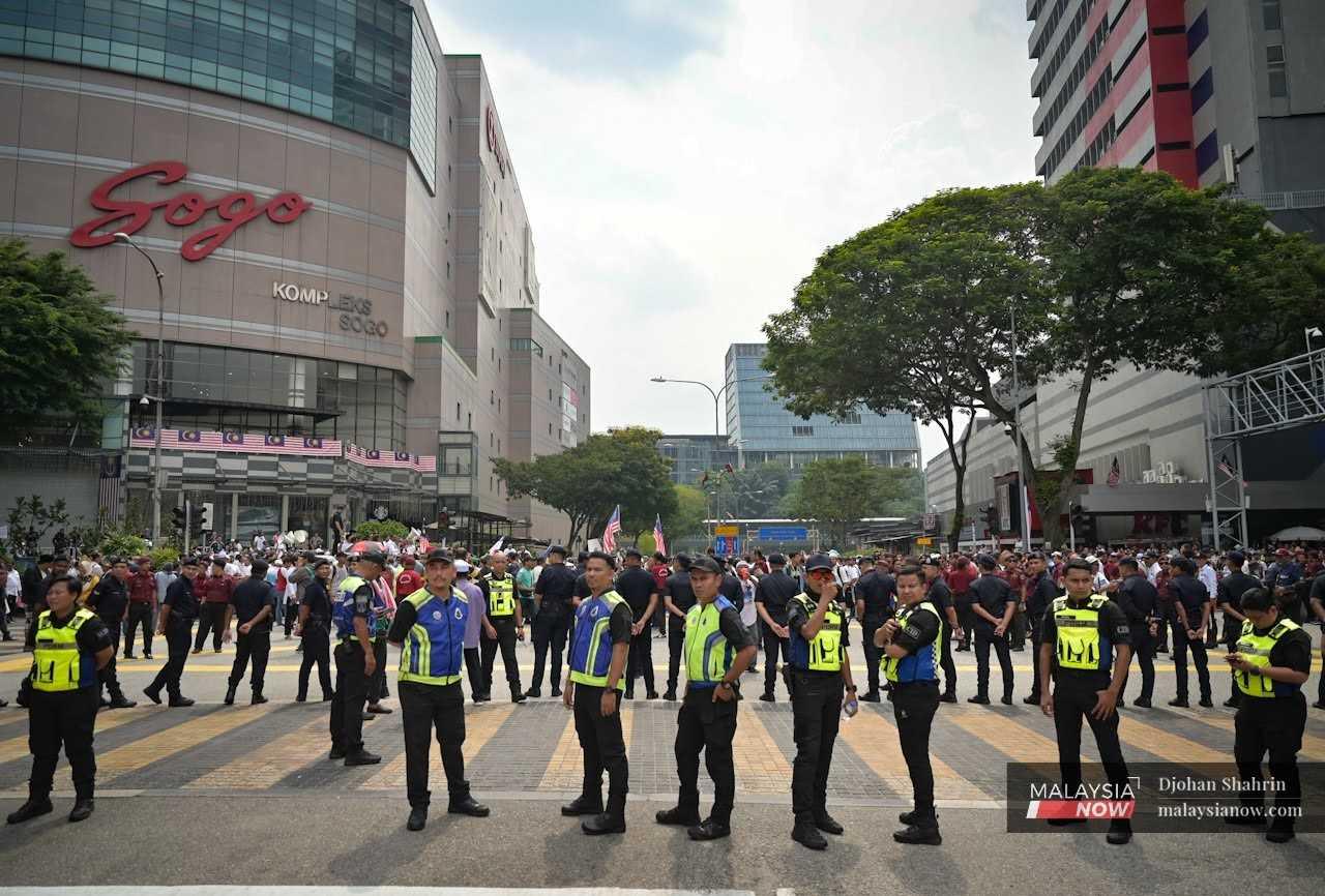 Police personnel stand by at Jalan Tuanku Abdul Rahman during the 'Save Malaysia' rally in Kuala Lumpur, Sept 16. 