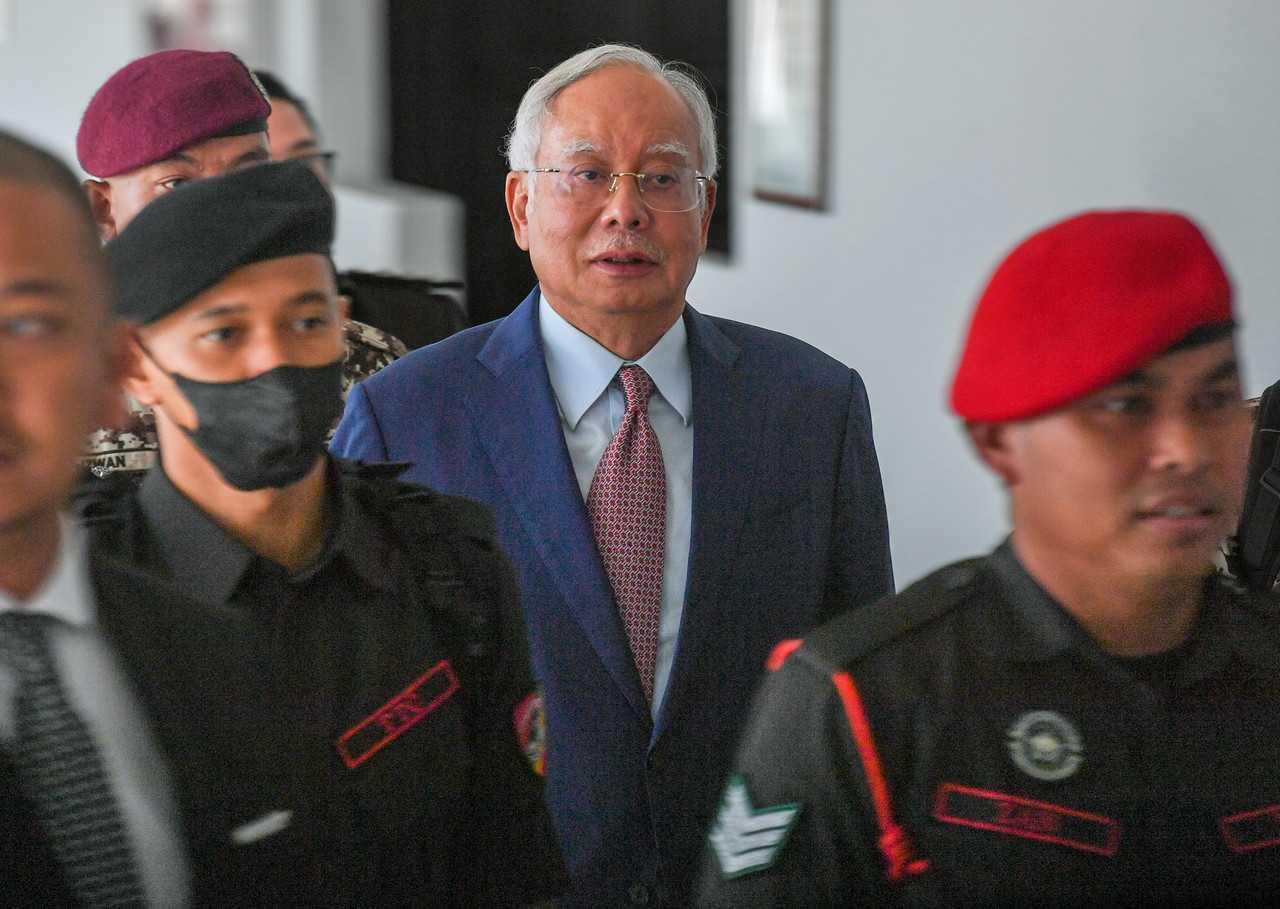 Former prime minister Najib Razak, escorted by security personnel at an appearance in court. Photo: Bernama