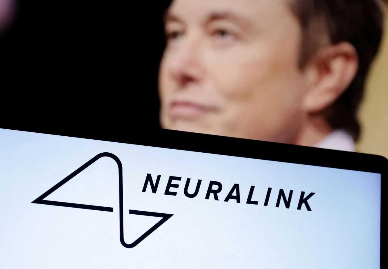 Neuralink logo and Elon Musk photo are seen in this illustration taken, Dec 19, 2022. Photo: Reuters