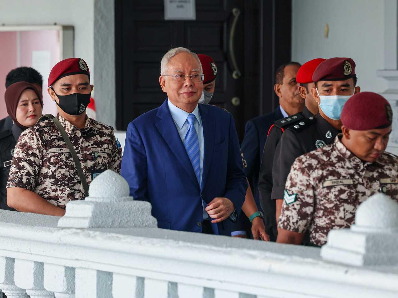 Former prime minister Najib Razak, escorted by security personnel at a court hearing in Kuala Lumpur. Photo: Bernama