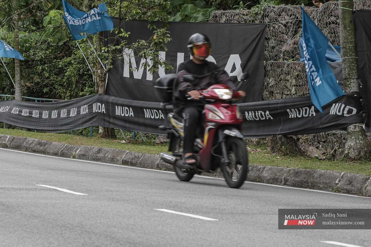 A motorcyclist rides past Muda flags in Bukit Antarabangsa, Selangor, ahead of the state election in August.