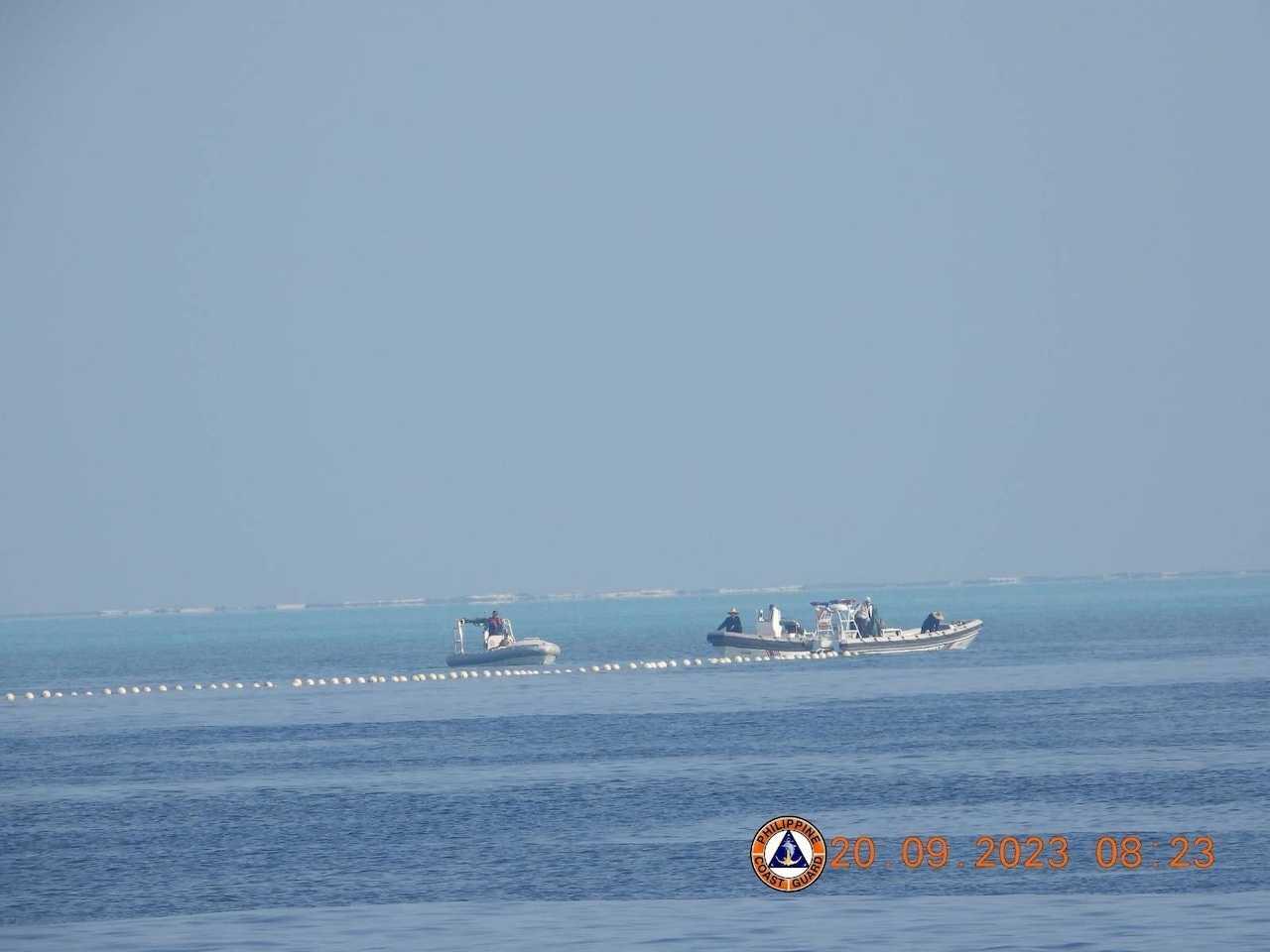 Chinese Coast Guard boats close to a floating barrier on Sept 20, near the Scarborough Shoal in the South China Sea, in this handout image released by the Philippine Coast Guard on Sept 24. Photo: Reuters