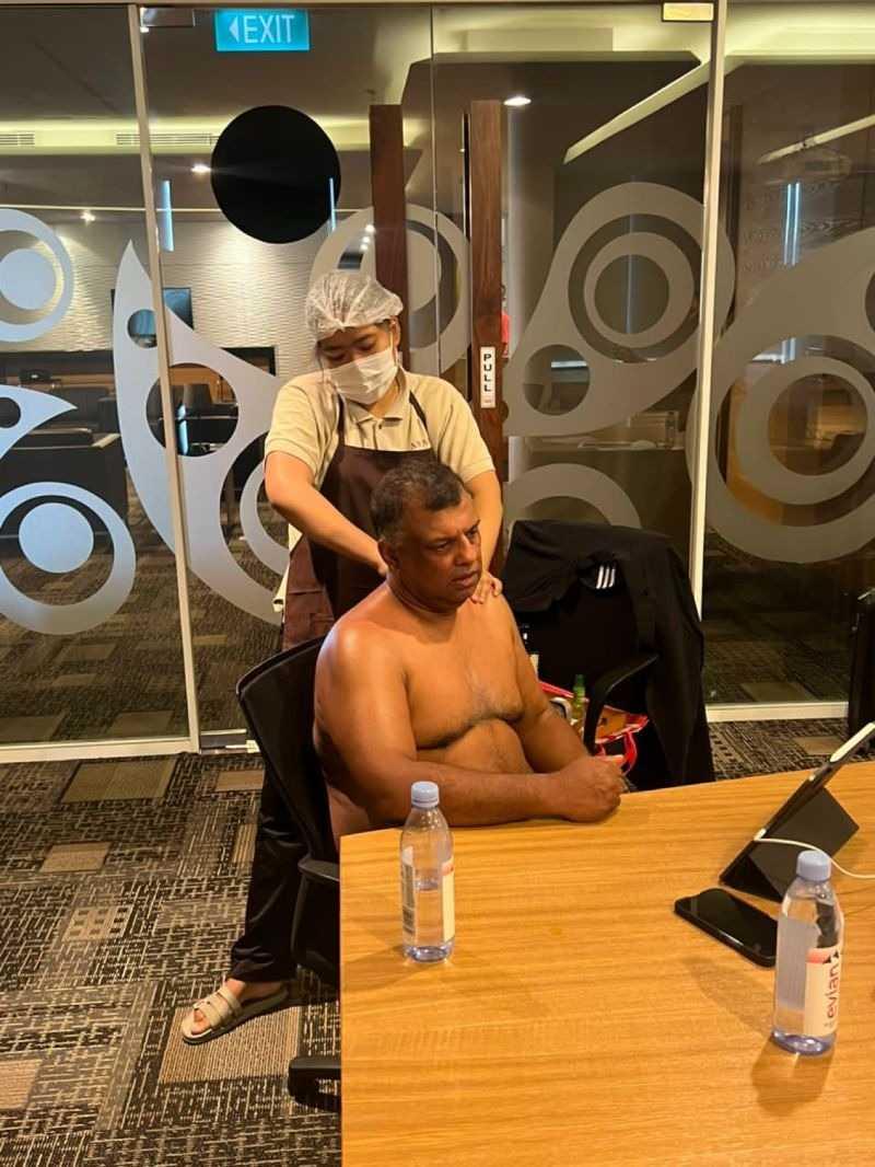 AirAsia boss Tony Fernandes receiving a back rub during a meeting in Indonesia.