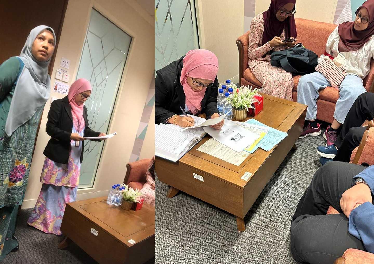 Two officers (standing) attend to the stateless siblings at the National Registration Department office in Putrrajaya. Lawyers for Liberty says multiple officers from the department harassed the siblings, including by accusing them of making the process difficult due to the presence of lawyers.