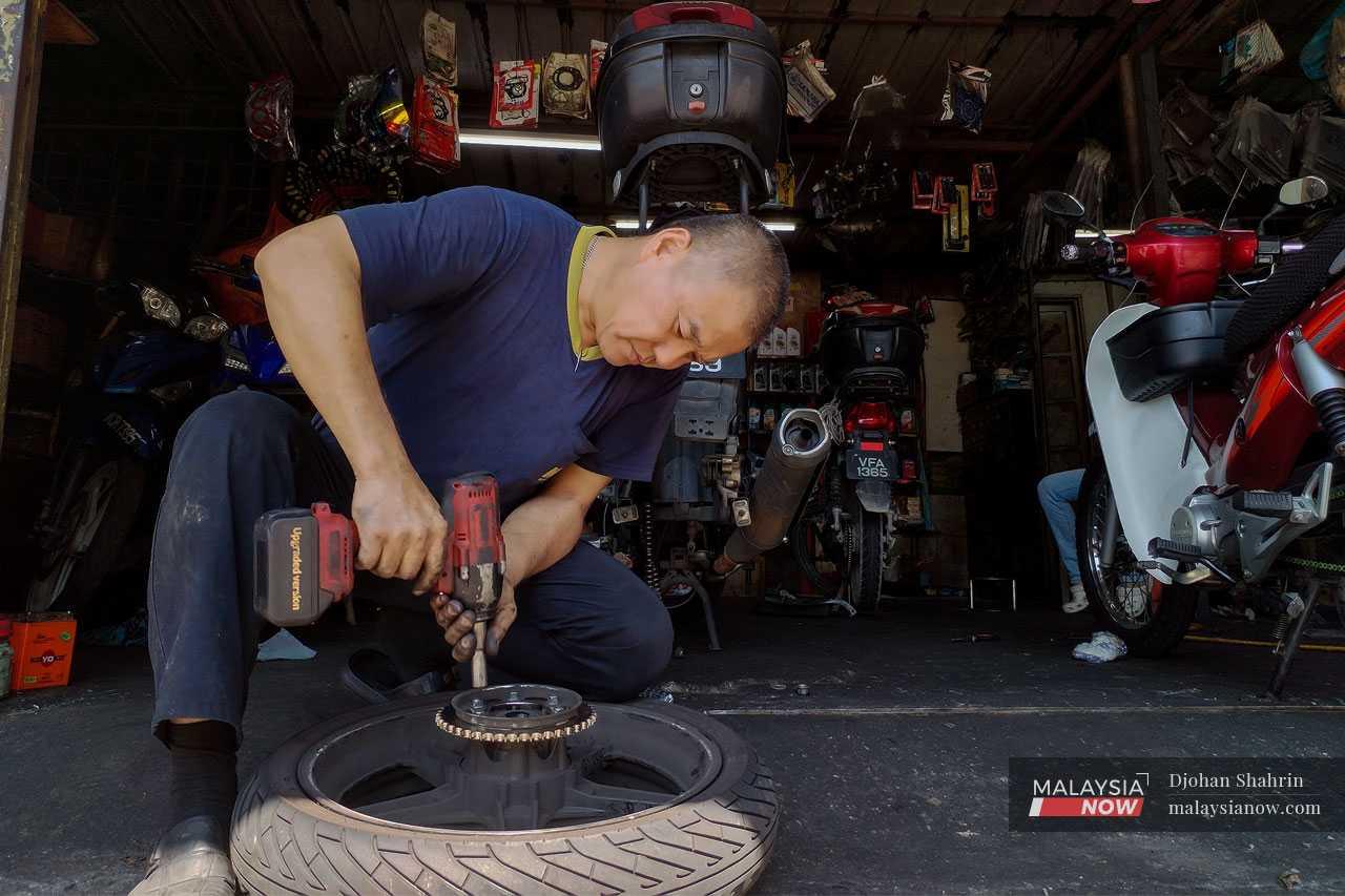 Mechanic Foo Weng, 51, has had no choice but to raise the price of his services to keep up with the cost of his supplies and equipment, much of which is imported from other countries. He was reluctant to do so, as he understands the plight of ordinary Malaysians, but has no other way to stay in business.