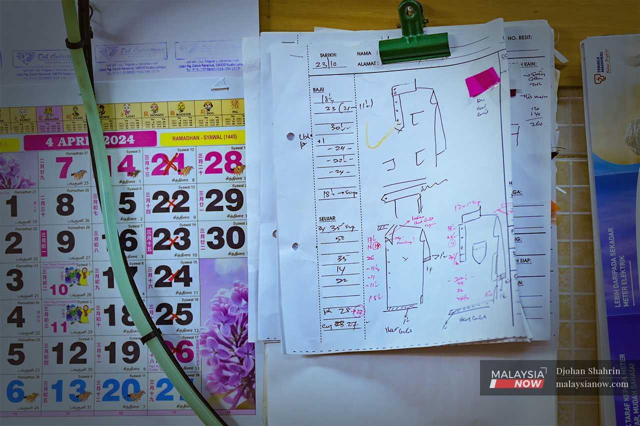 His sketches and drafts are pinned up on the wall beside the calendar which he uses to count down the days left until Hari Raya.