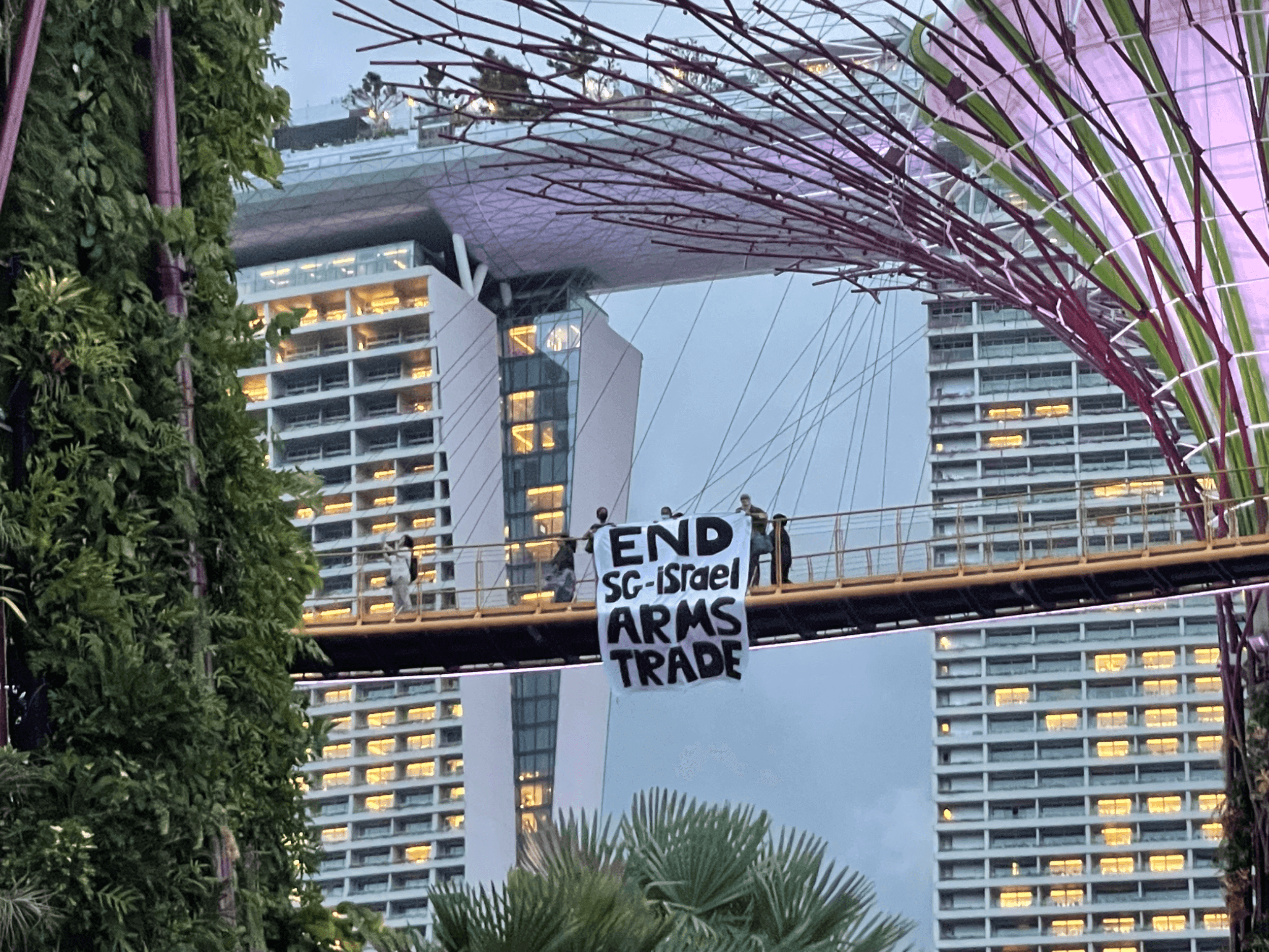 A group calling for an end to military ties with Israel unfurls a banner on a bridge in Singapore, April 15, 2024.