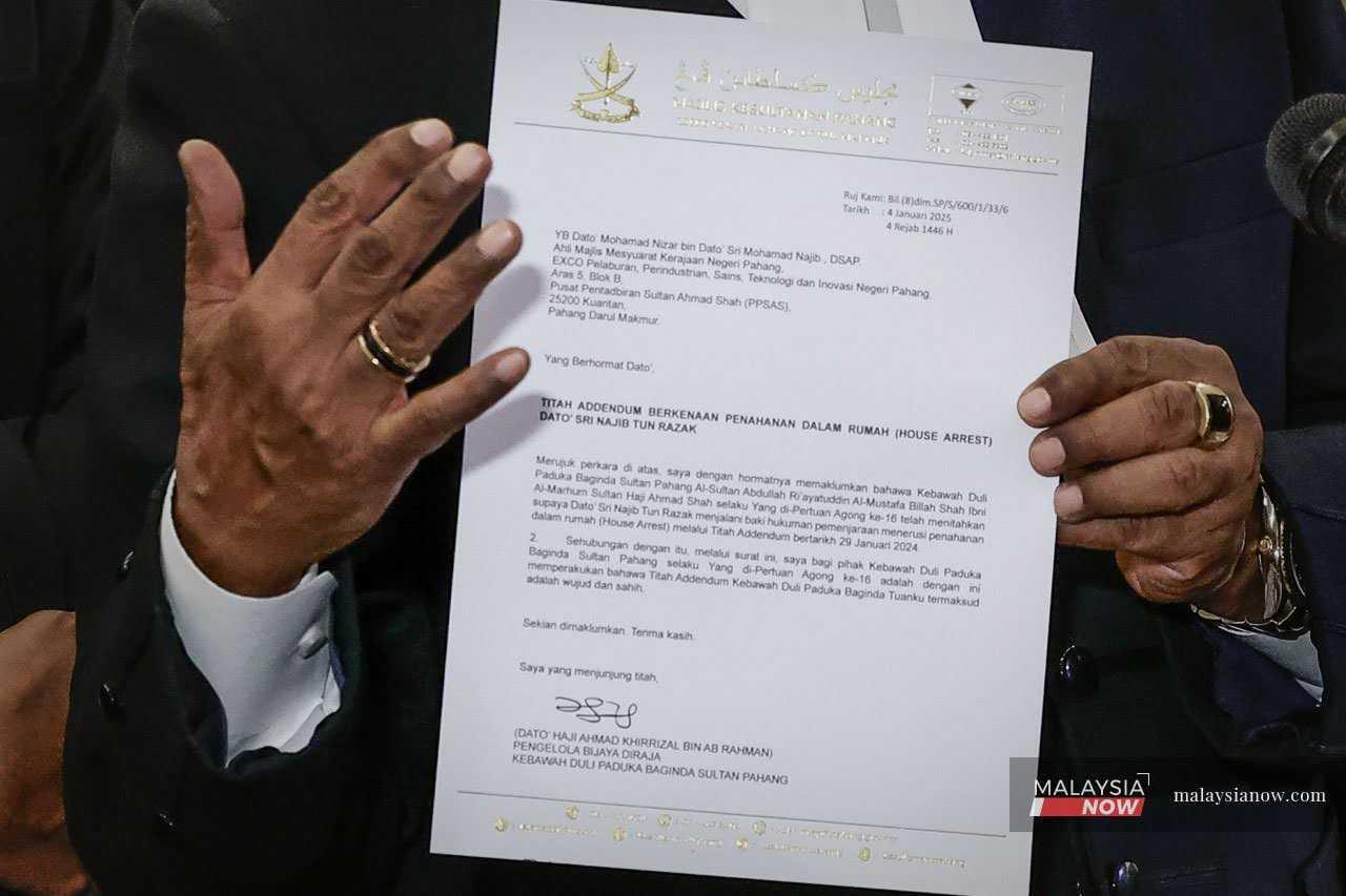 Lawyer Muhammad Shafee Abdullah shows a letter from the Pahang palace confirming Sultan Abdullah Sultan Ahmad Shah's request for Najib Razak to serve the remainder of his jail sentence at home.