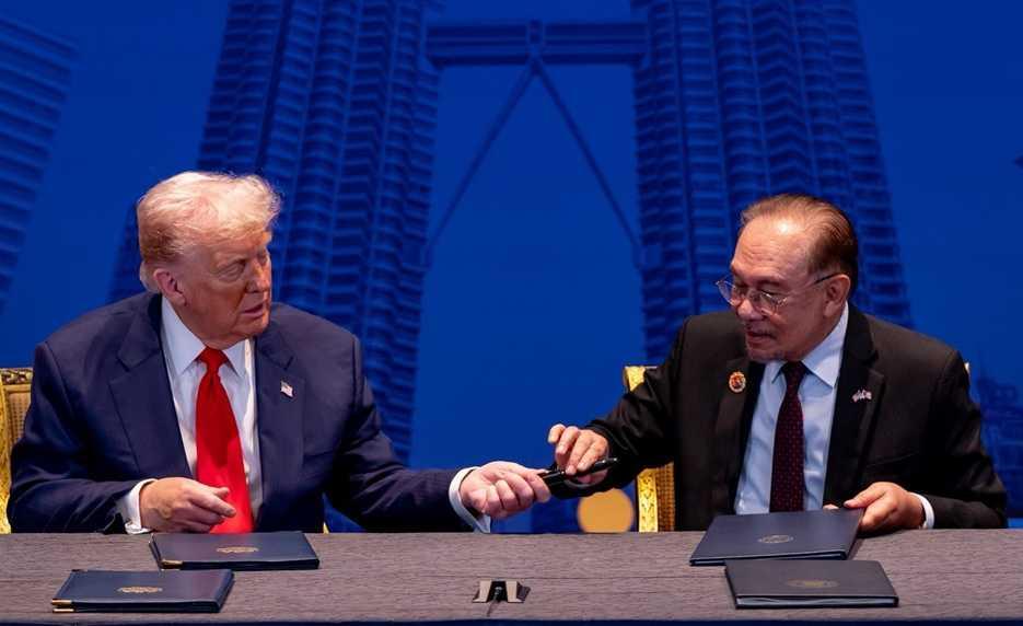 Donald Trump gifts Anwar Ibrahim a pen shortly after the prime minister signs a trade agreement in which Malaysia commits itself to align with US interests.