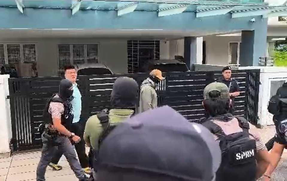 Albert Tei being led out of his home by masked gunmen from MACC on Nov 28, 2025.