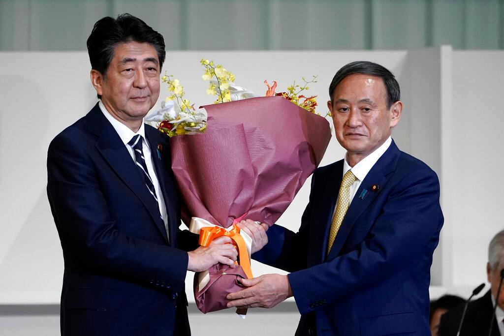 Yoshihide Suga (right) with Japanese Prime Minister Shinzo Abe. Photo: AP