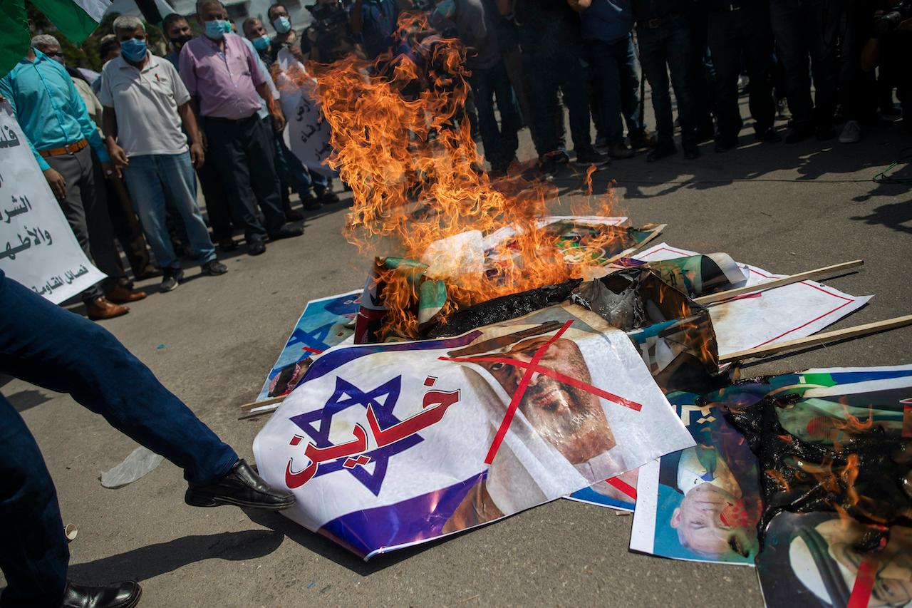 Palestinians burn pictures of US President Donald Trump, Israeli Prime Minister Benjamin Netanyahu, Bahrain's King Hamad bin Isa Al Khalifa and and Abu Dhabi Crown Prince Mohammed bin Zayed al-Nahyan, during a protest against the UAE-Bahraini normalisation agreement with Israel, in Gaza City, Sept 15, 2020. Photo: AP
