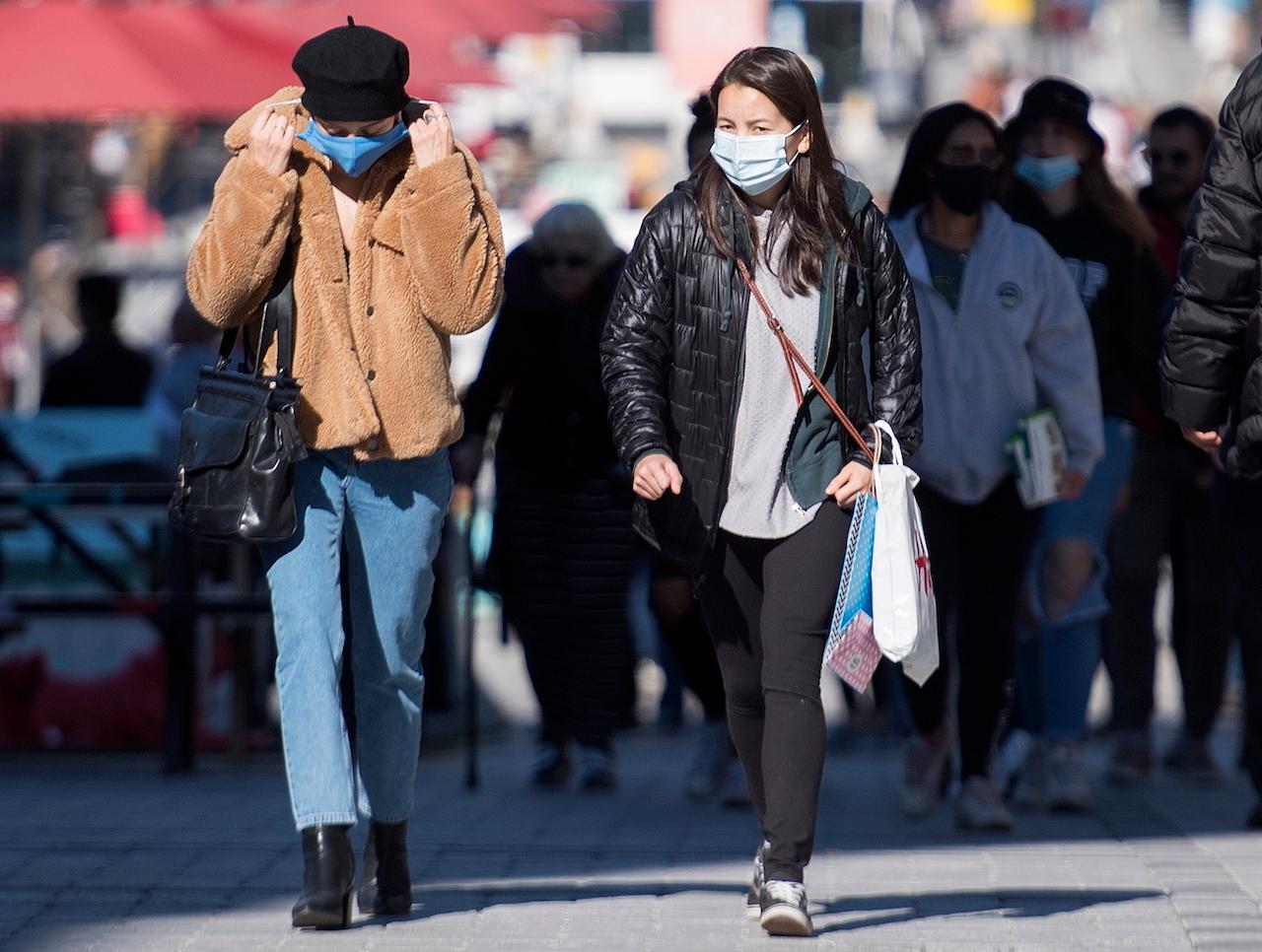 People wear face masks on a street in Montreal on Sept 20, as the Covid-19 pandemic continues in Canada and around the world. Photo: AP