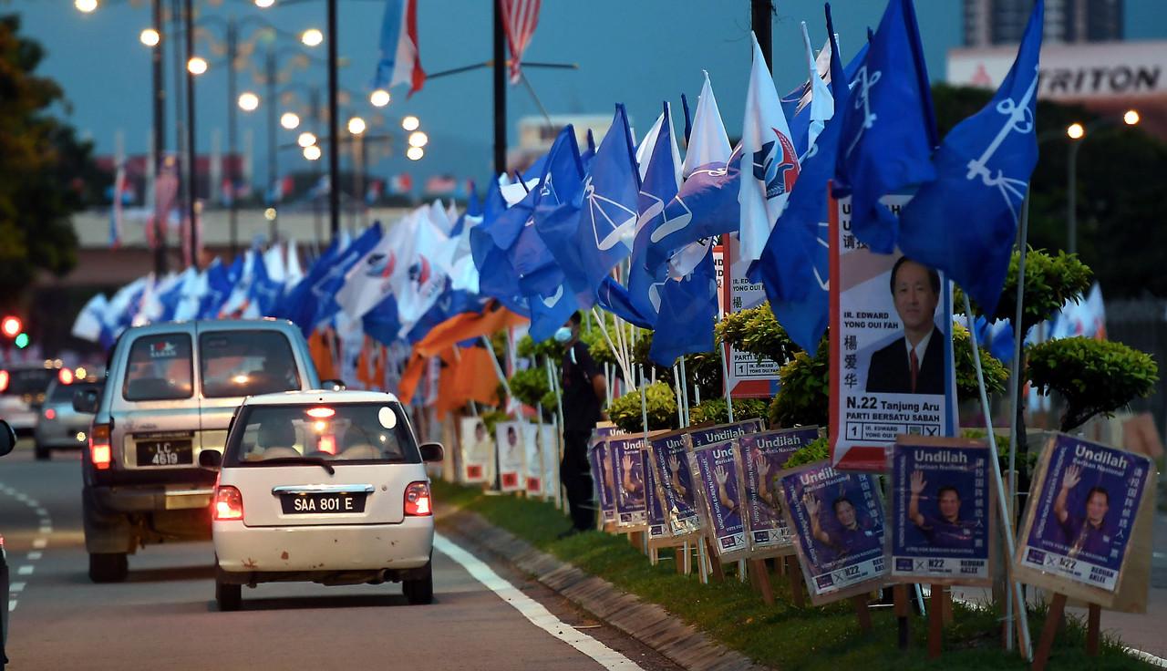Party flags and posters seen along a road in Kota Kinabalu, Sabah, where voters decide on a new state government on Sept 26. Photo: Bernama