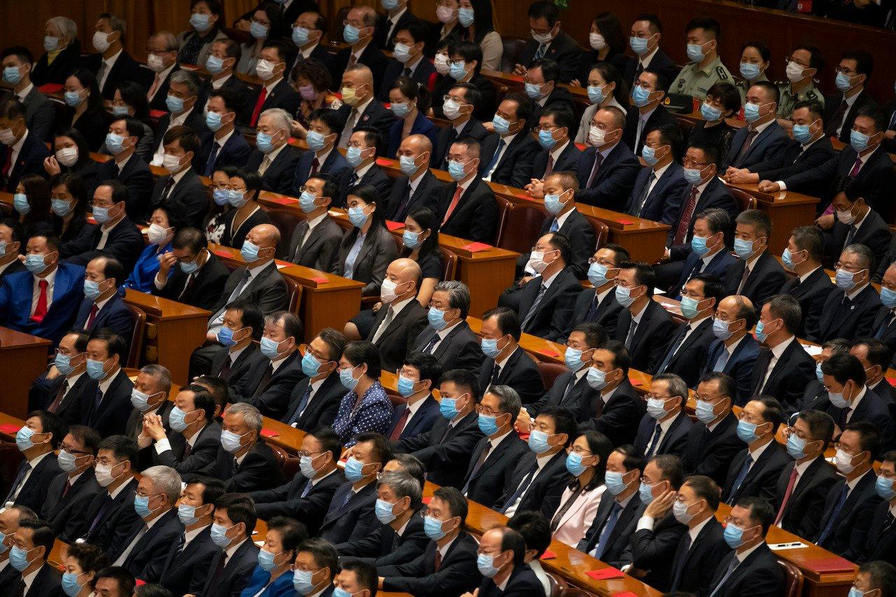 Attendees wearing face masks watch an event to honour some of those involved in China's fight against Covid-19 at the Great Hall of the People in Beijing, Sept 8. Photo: AP