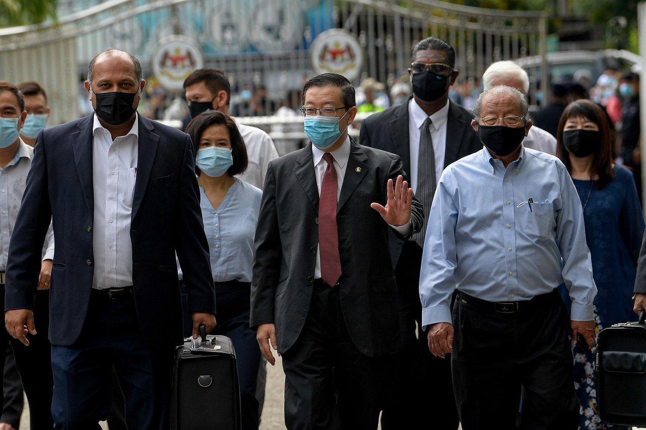DAP secretary-general Lim Guan Eng with Gobind Singh Deo (left), RSN Rayer and his father, party veteran Lim Kit Siang, at the Sessions Court in Butterworth after claiming trial to misappropriating state property on Sept 11. Photo: Bernama