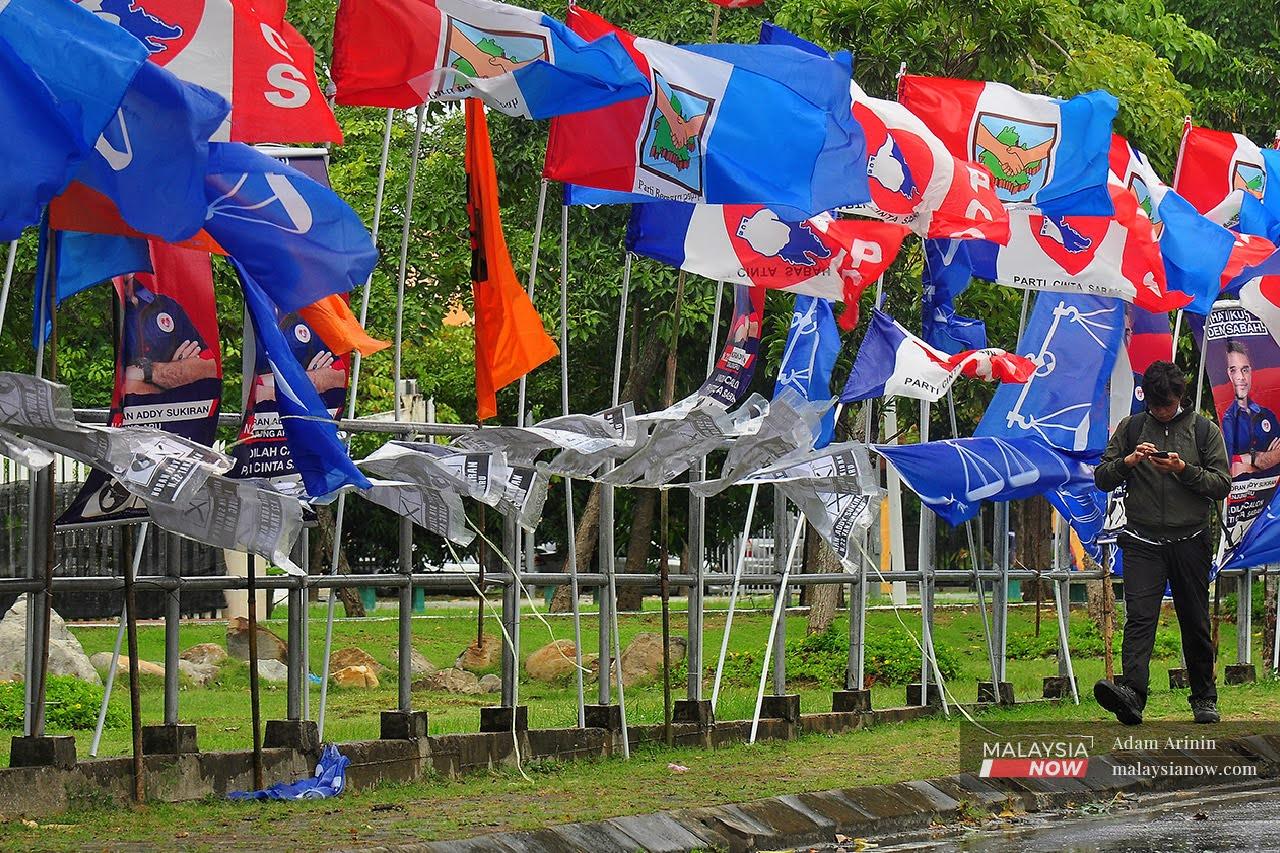 Party flags wave in the breeze today, as voters head out to polling centres across Sabah.