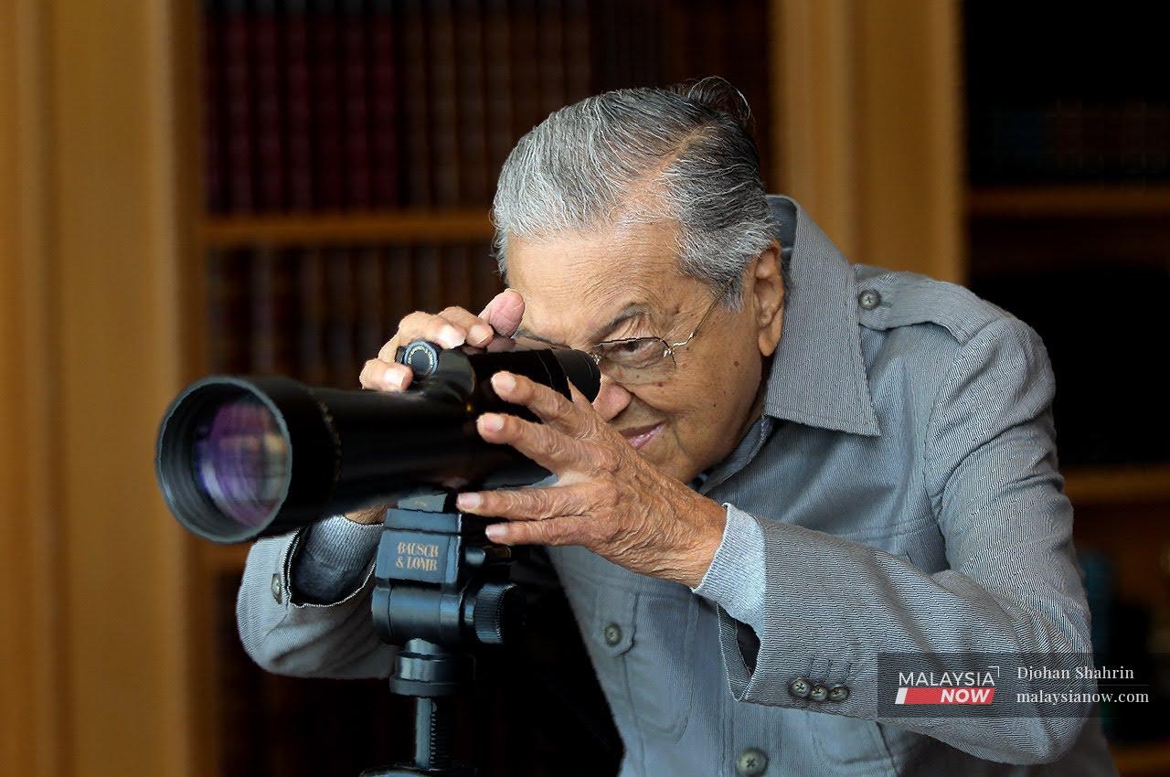 Former prime minister Dr Mahathir Mohamad looks through a telescope in his office at Yayasan Kepimpinan Perdana in Putrajaya.