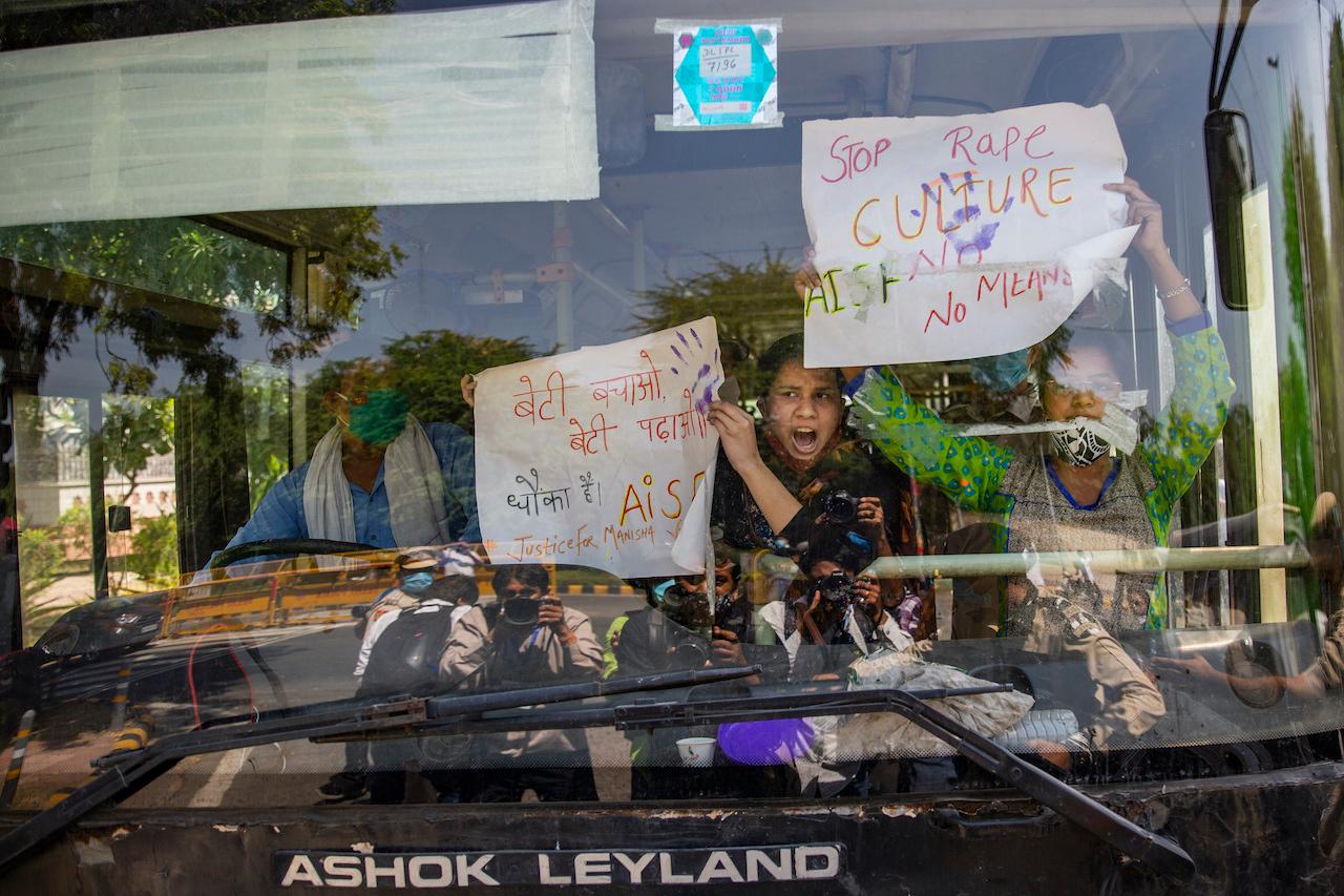 Indian activists hold placards and shout slogans from inside a bus after being detained during a protest in New Delhi on Sept 30 against the gang rape and killing of a woman from the Dalit caste. Photo: AP