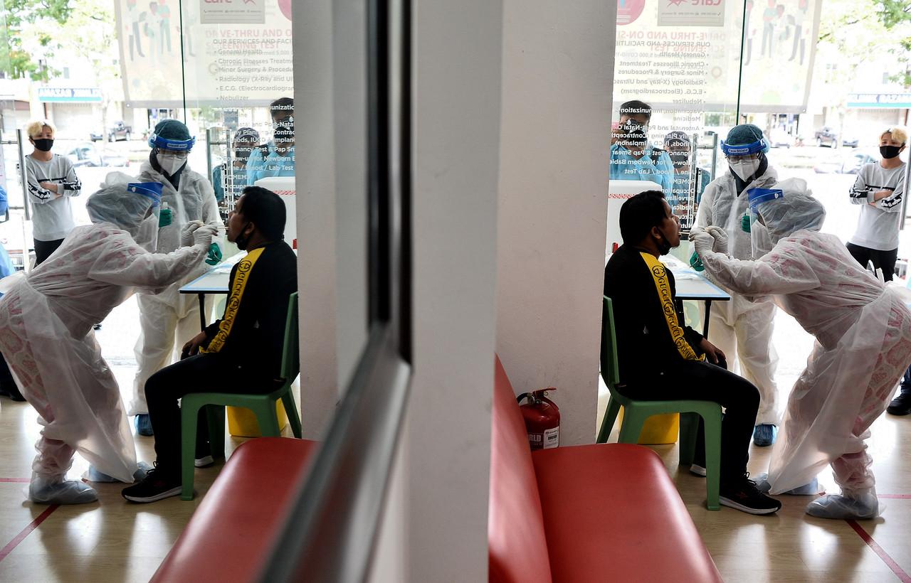 A man is screened for Covid-19 at a Selcare clinic in Shah Alam. Photo: Bernama