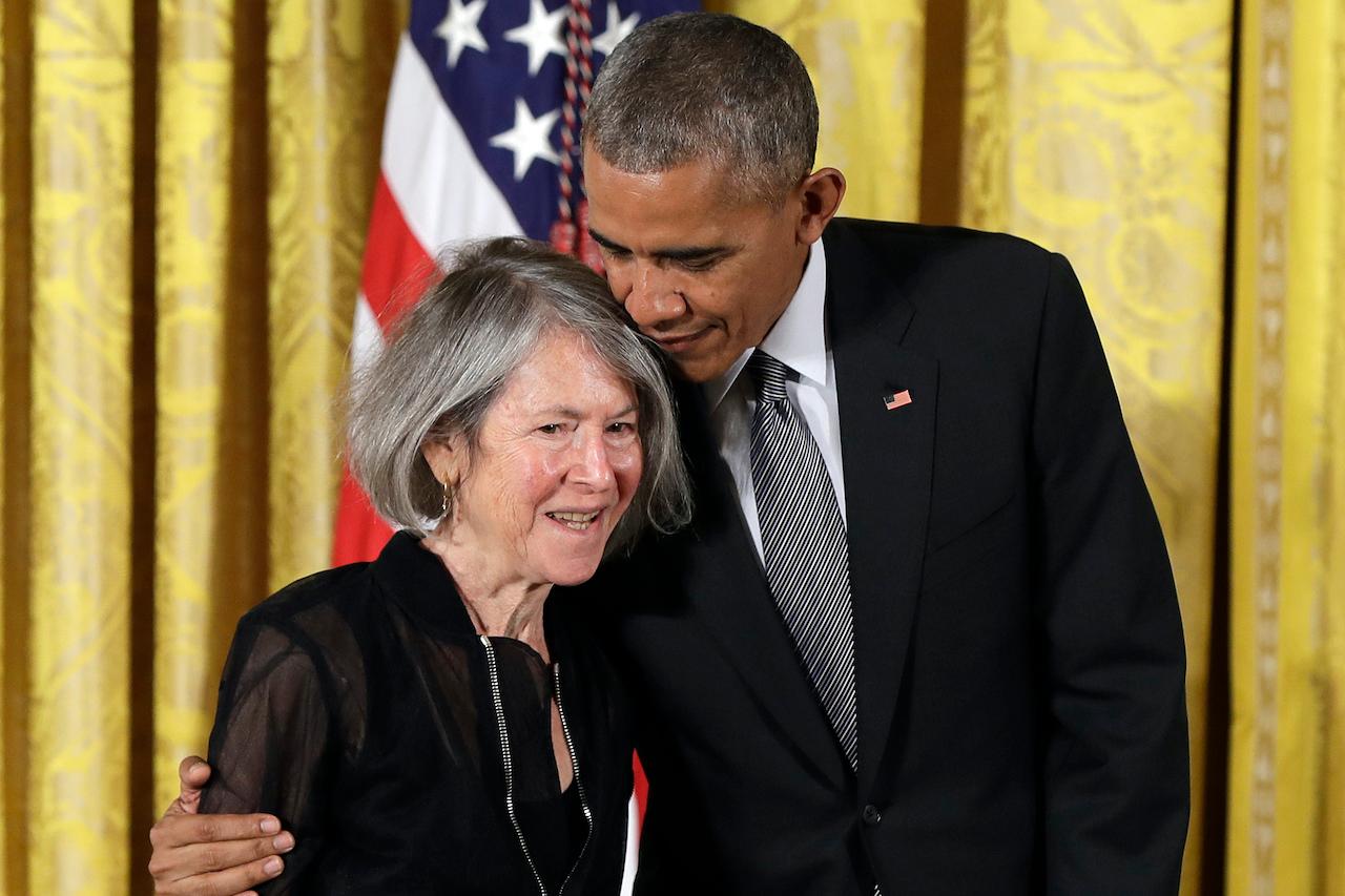 US President Barack Obama embraces poet Louise Gluck before awarding her the 2015 National Humanities Medal at the White House in Washington on Sept 22, 2016. Photo: AP