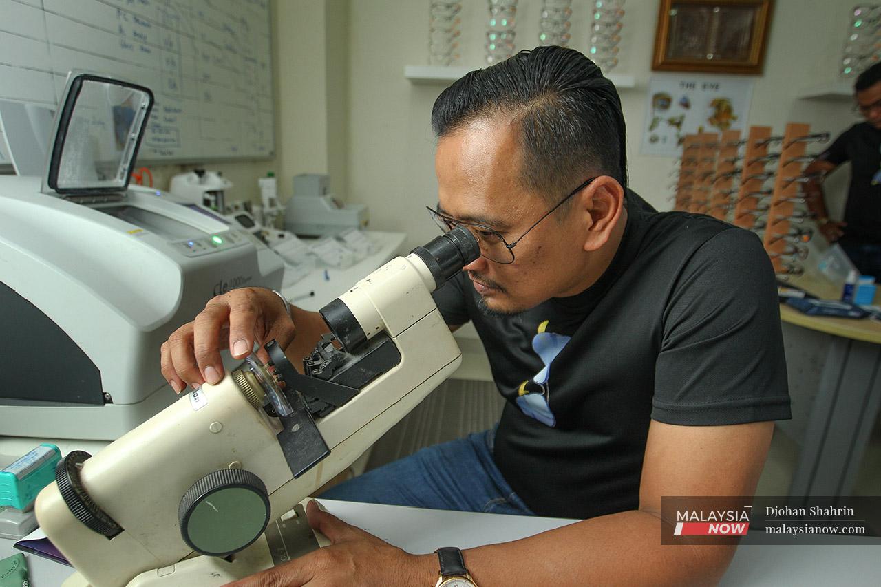 Rafiz uses a lensometer to verify the prescription for the glasses he makes. Much of an optician's job is now computerised, but this part requires knowledge and experience.