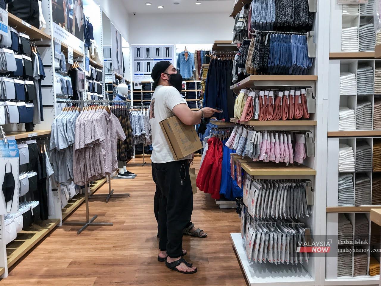 Shoppers browse through the selection at a Uniqlo outlet in the Klang Valley.