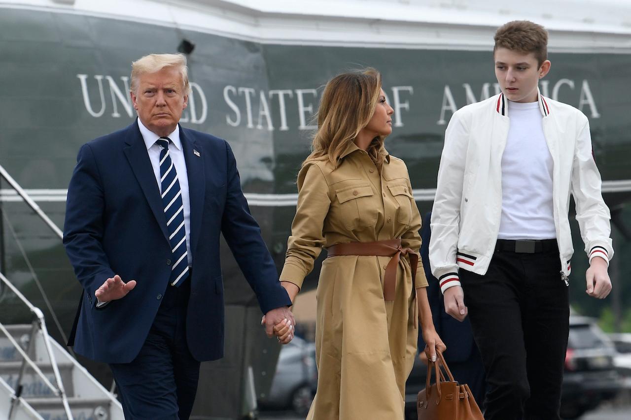 US President Donald Trump, first lady Melania Trump and their son, Barron Trump, walk off of Marine One and head toward Air Force One at Morristown Municipal Airport in Morristown, New Jersey, on Aug 16. Photo: AP