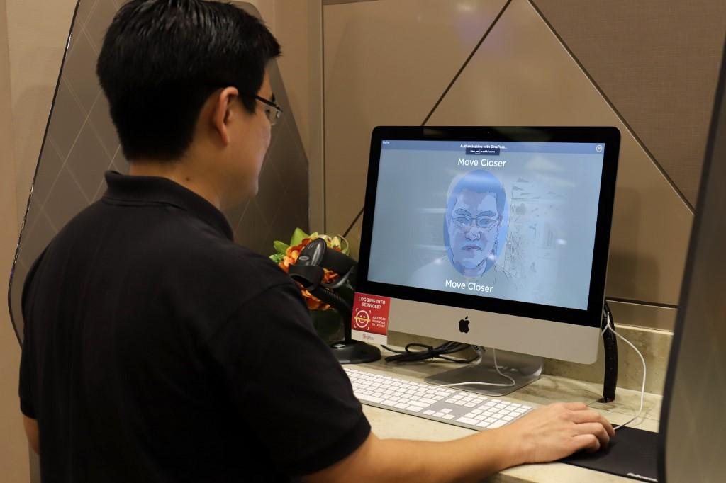 A staff member of government technology agency GovTech demonstrates the use of facial verification technology to access government services in Singapore. Photo: AFP