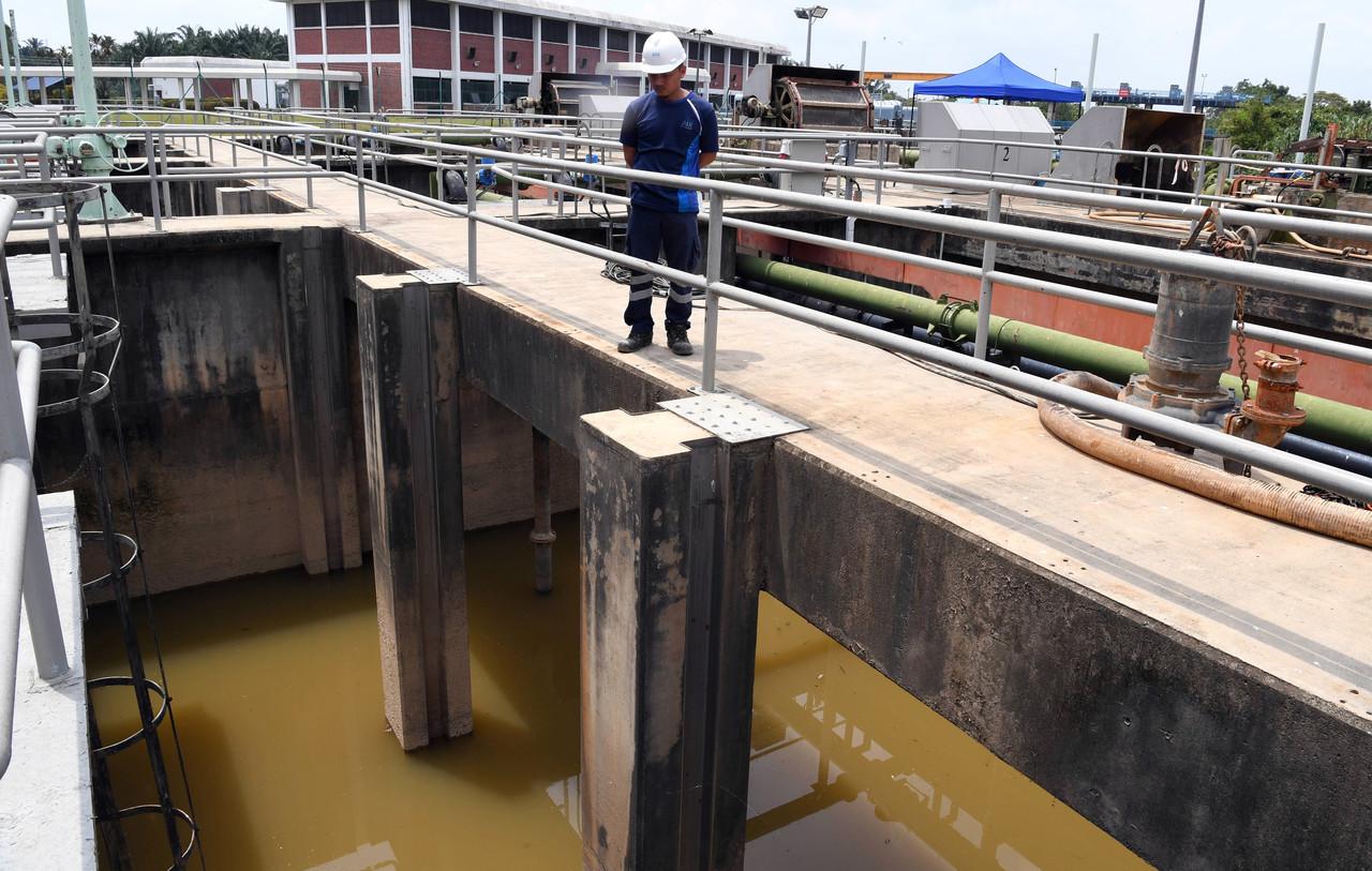 A worker checks the water quality at the Sungai Selangor Phase 2 water treatment plant after a disruption in water supply last month. Photo: Bernama