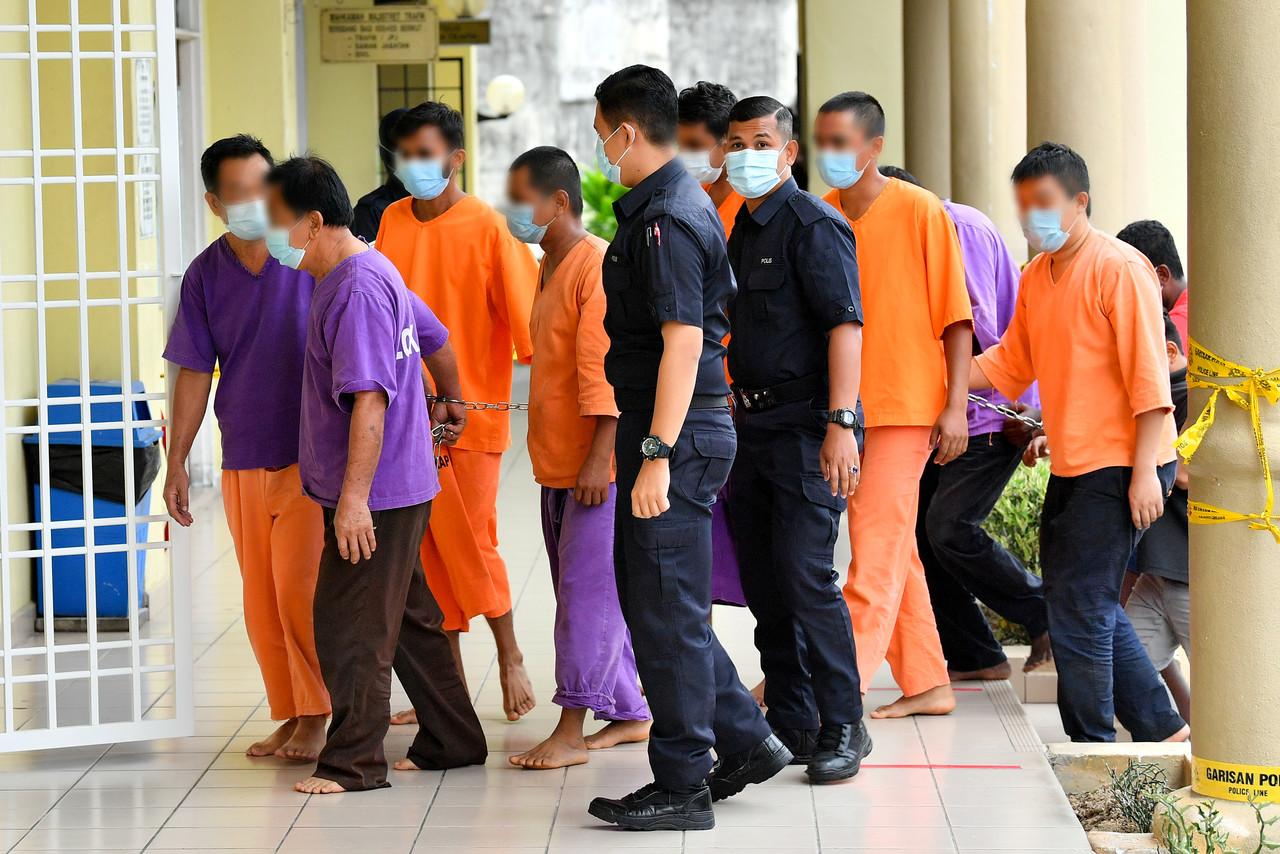 The eight men being led into the Selayang courts complex this morning. Photo: Bernama