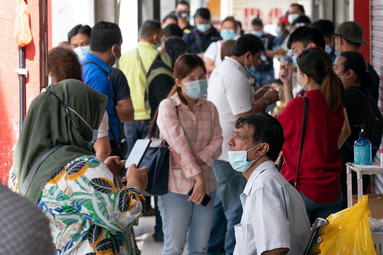 People wait for their turn to be screened for Covid-19 at a clinic in Kajang, Oct 23. Photo: AP