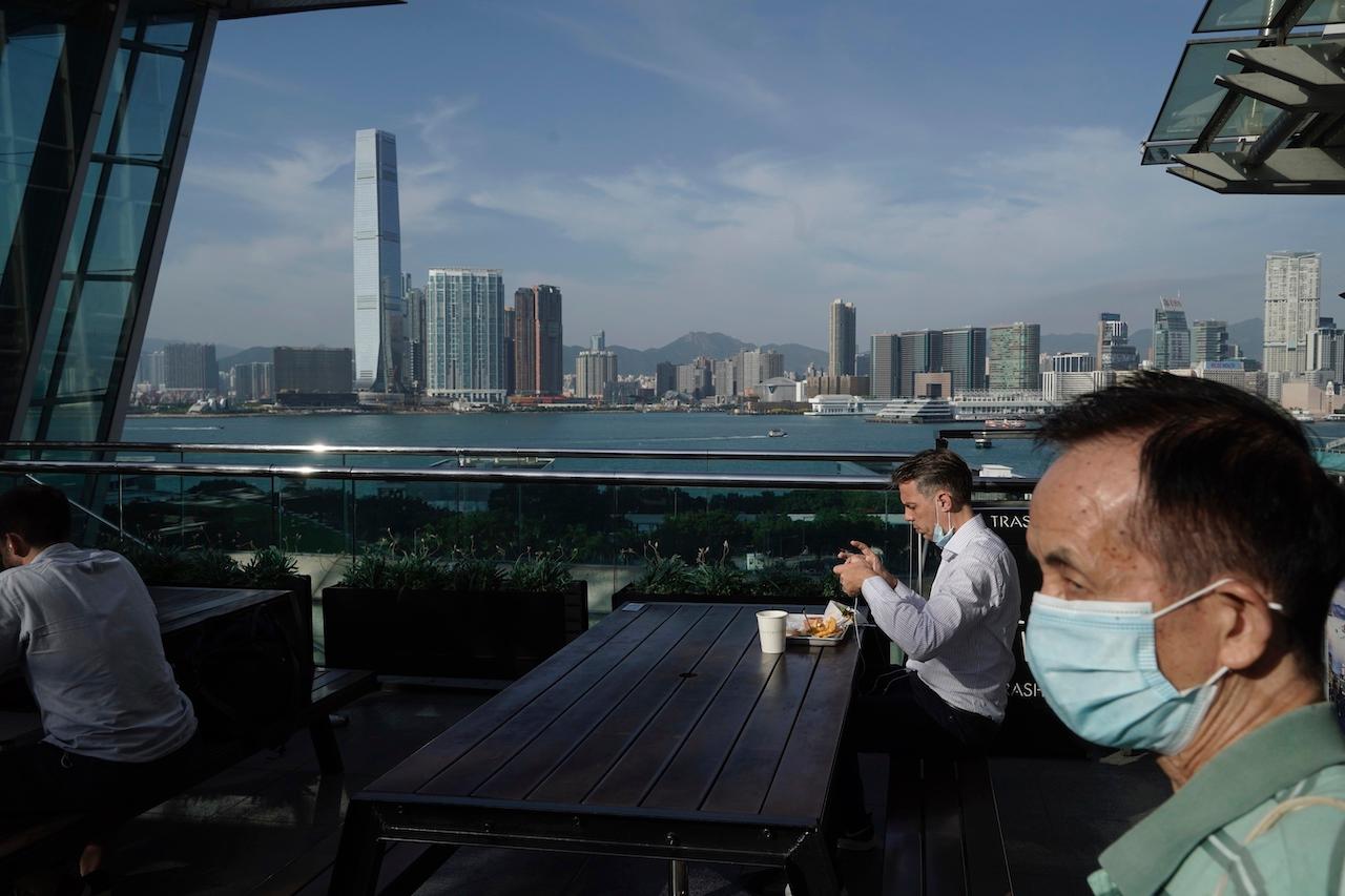 A man eats in a restaurant at waterfront in Hong Kong, Oct 15. Photo: AP