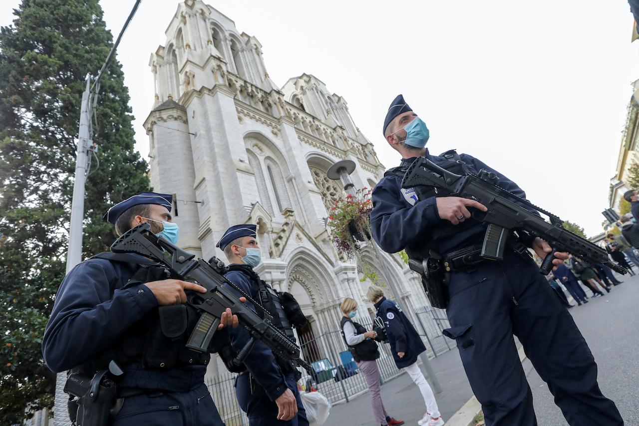French police officers stand near the Notre Dame church in Nice, southern France on Oct 29. Photo: AP