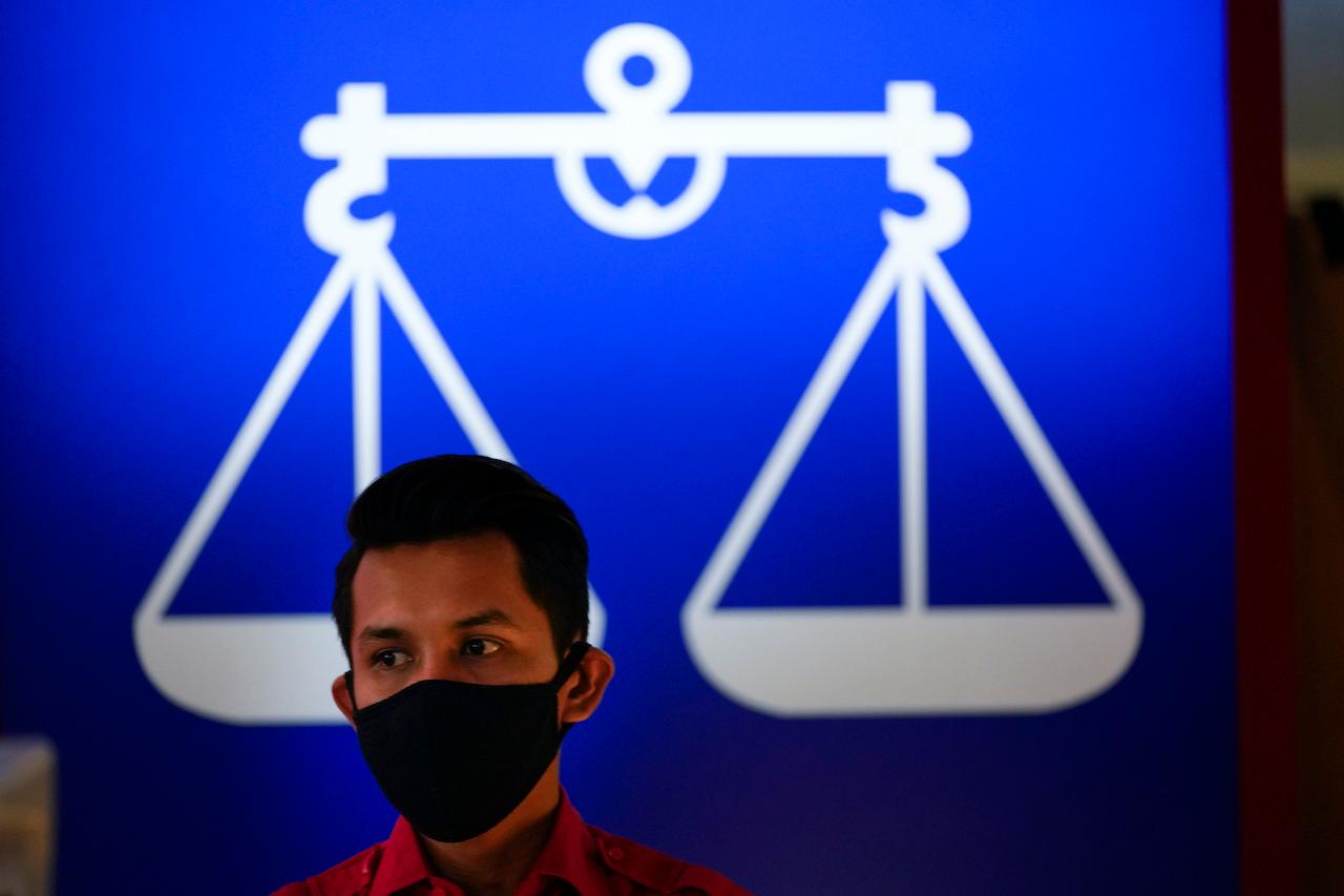 The opinion poll on the use of Barisan Nasional's 'scale' symbol is being held among the coalition's communication workers nationwide. Photo: AP