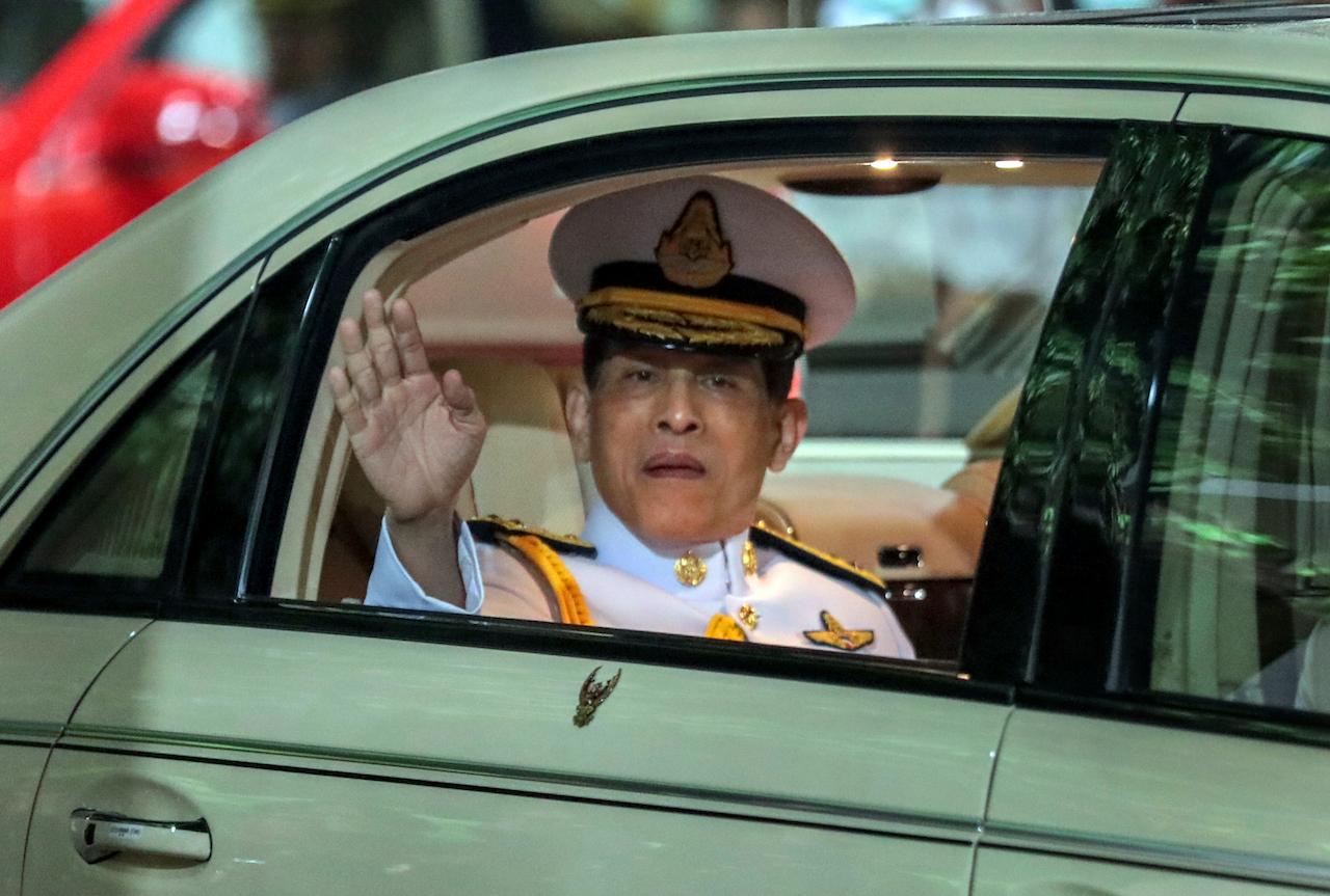 Thailand's King Maha Vajiralongkorn waves from his limousine after officiating a graduation ceremony in Bangkok, Thailand on Oct 31. Photo: AP