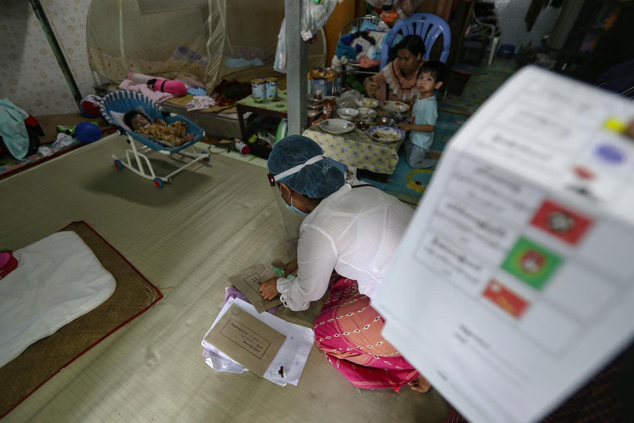 An election commission officer collects ballots after early voting for Myanmar's Nov 8 polls at a residence on the outskirts of Yangon on Oct 29. Photo: AP