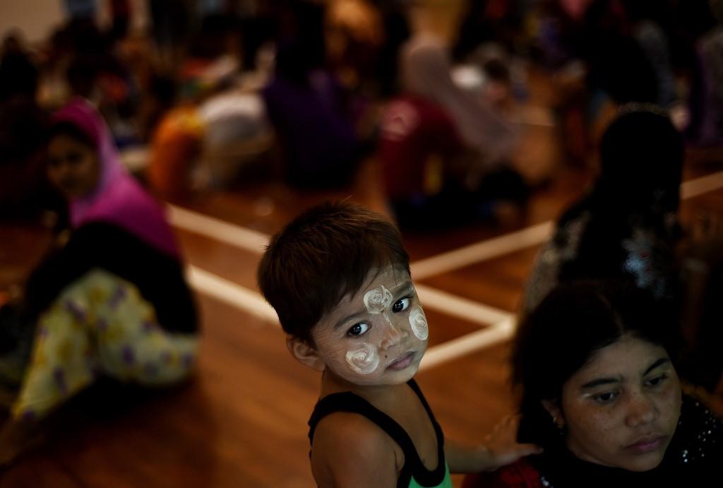 A young Rohingya boy waits with other illegal migrants at a temporary detention centre in Langkawi in this file picture taken on May 12, 2015. The government says over 700 children are currently being held at immigration centres. Photo: AFP
