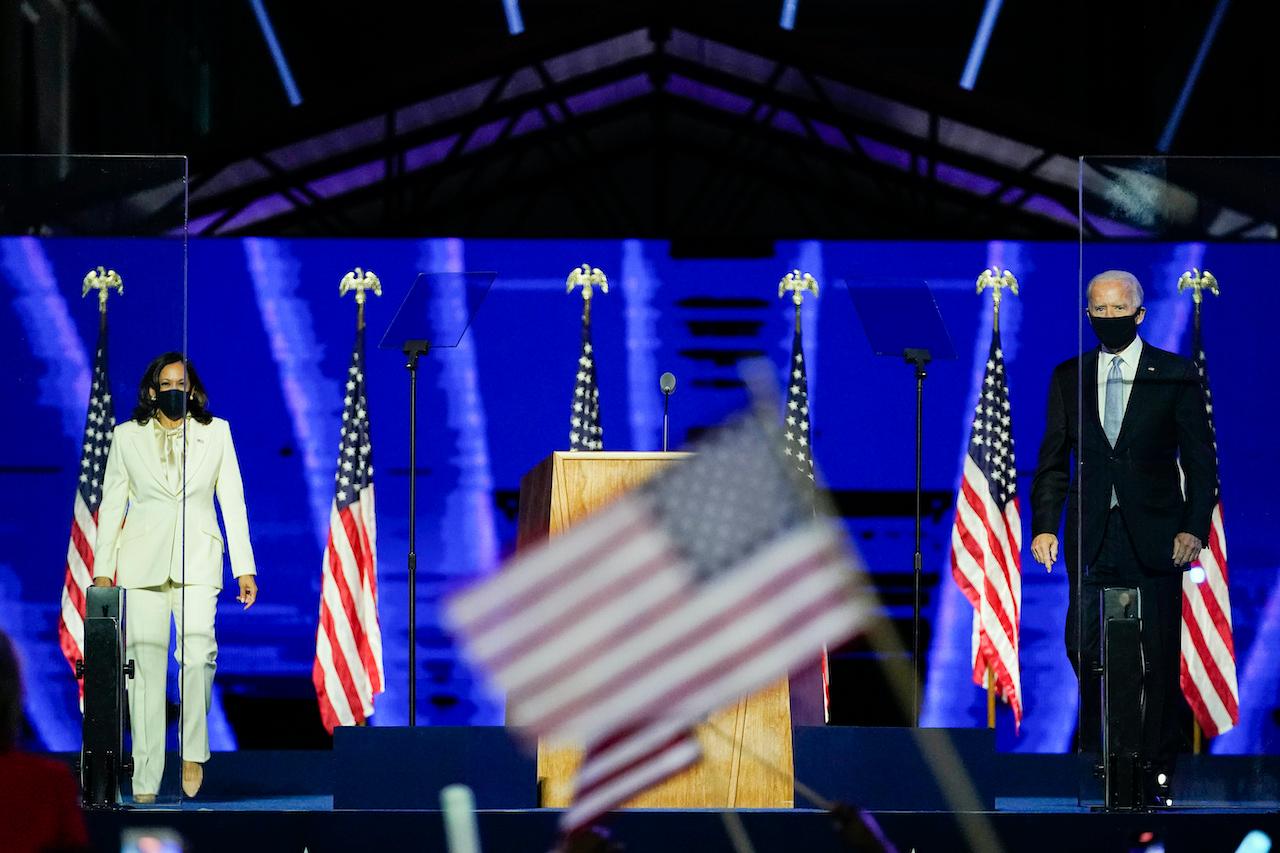 President-elect Joe Biden joins vice president-elect Kamala Harris on stage, Nov 7, in Wilmington, Delaware. Photo: AP