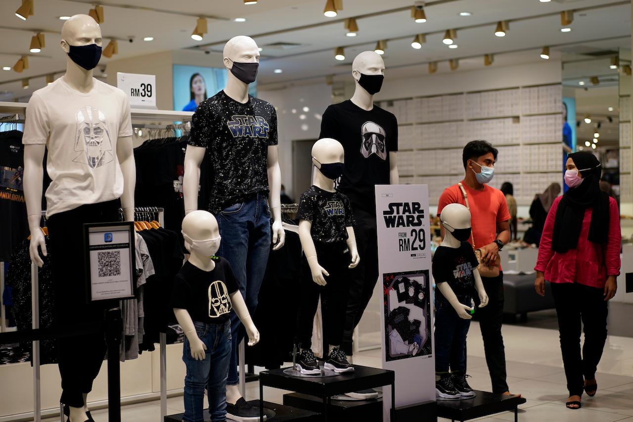 Shoppers stroll through a mall in Putrajaya, wearing face masks to prevent the spread of Covid-19. Photo: AP