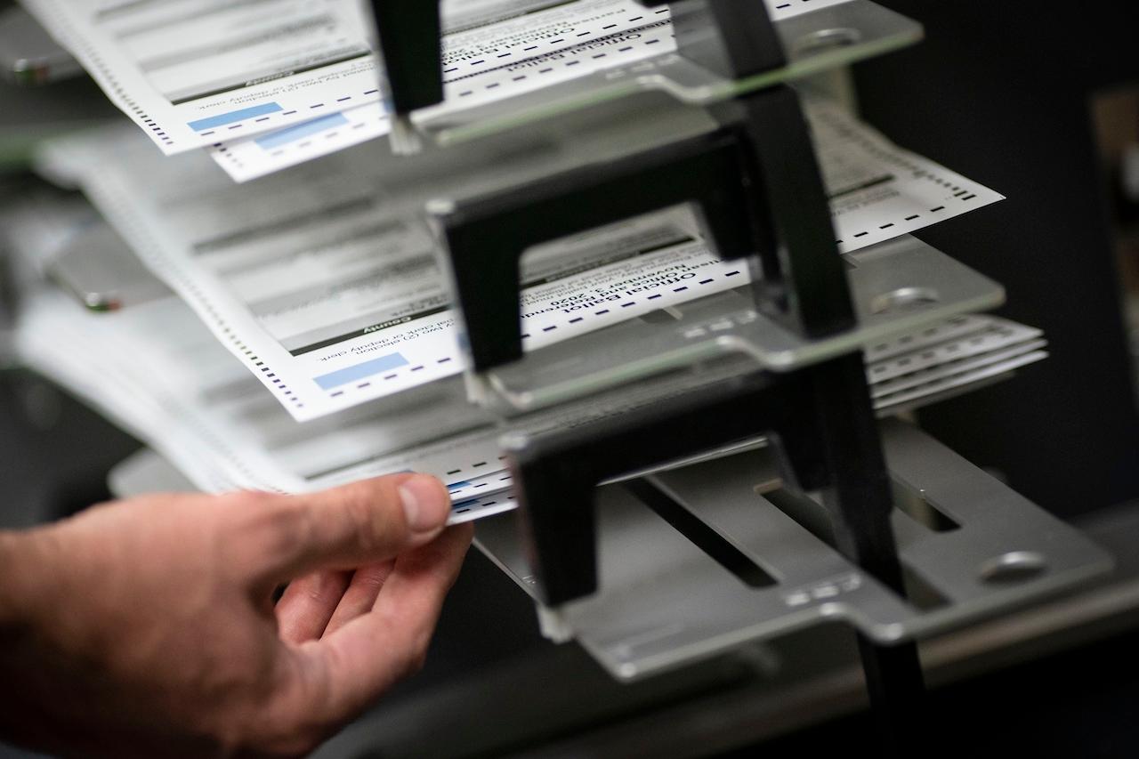Poll workers sort out early and absentee ballots at the Kenosha Municipal building on election day, in Kenosha, Wisconsin. Photo: AP