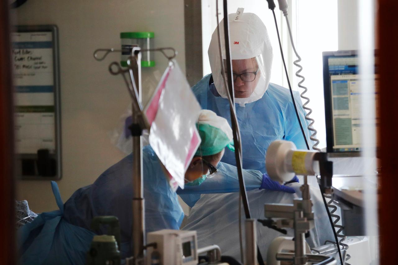 Nurses at a medical centre in Seattle tend to a patient in the Covid-19 ICU. Photo: AP