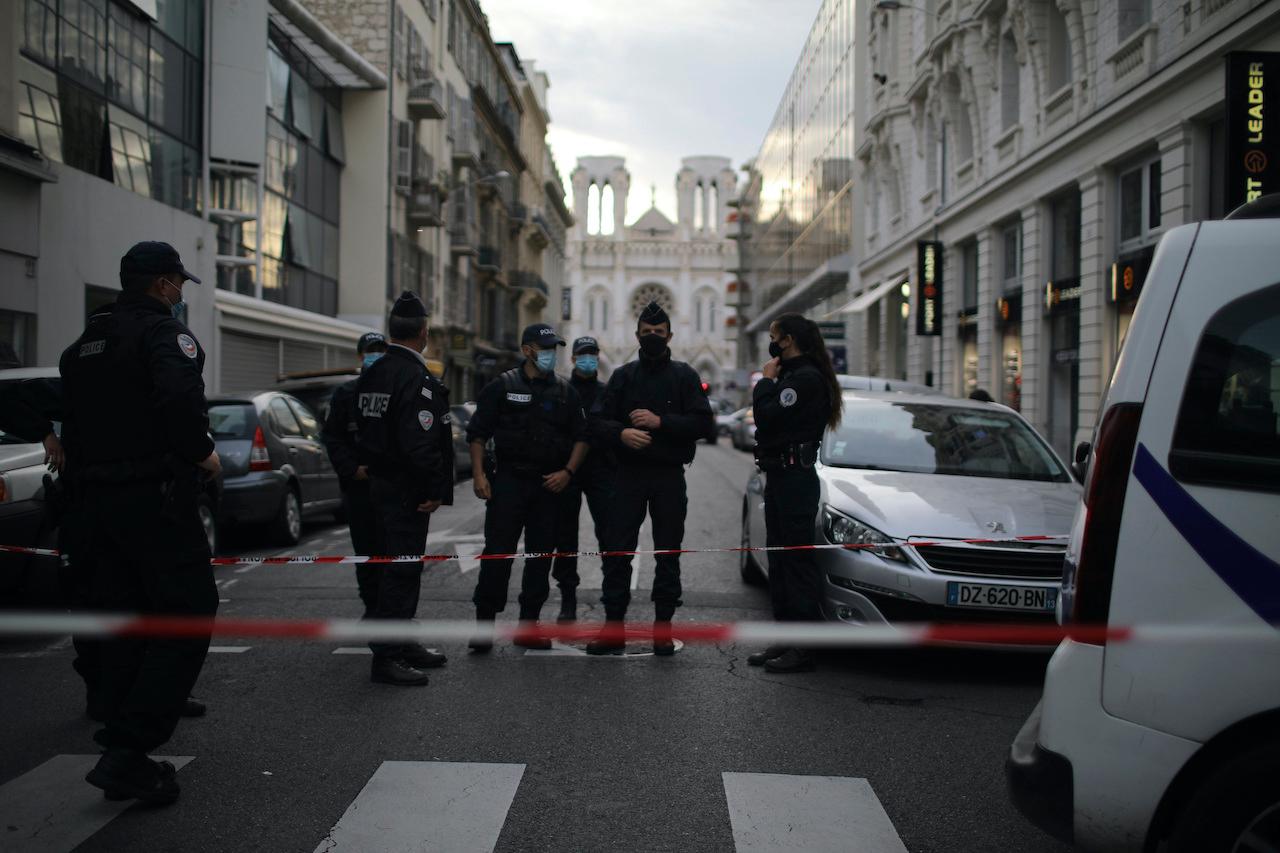 Police patrol a street outside the Notre Dame church in Nice, southern France, after a knife attack on Oct 29. Photo: AP