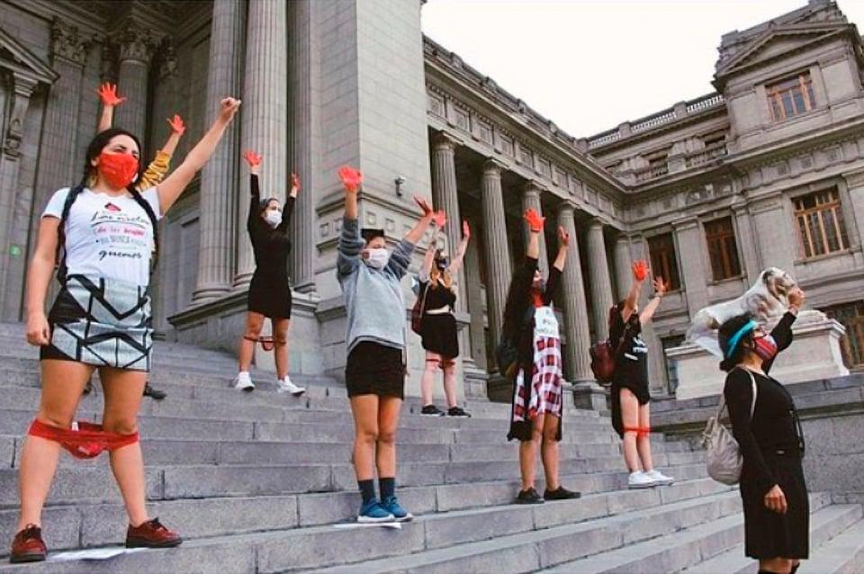 Protesters wearing red underwear around their knees demonstrate against a rape ruling by a court in Peru. Photo: @ica.feminista/Newsflash