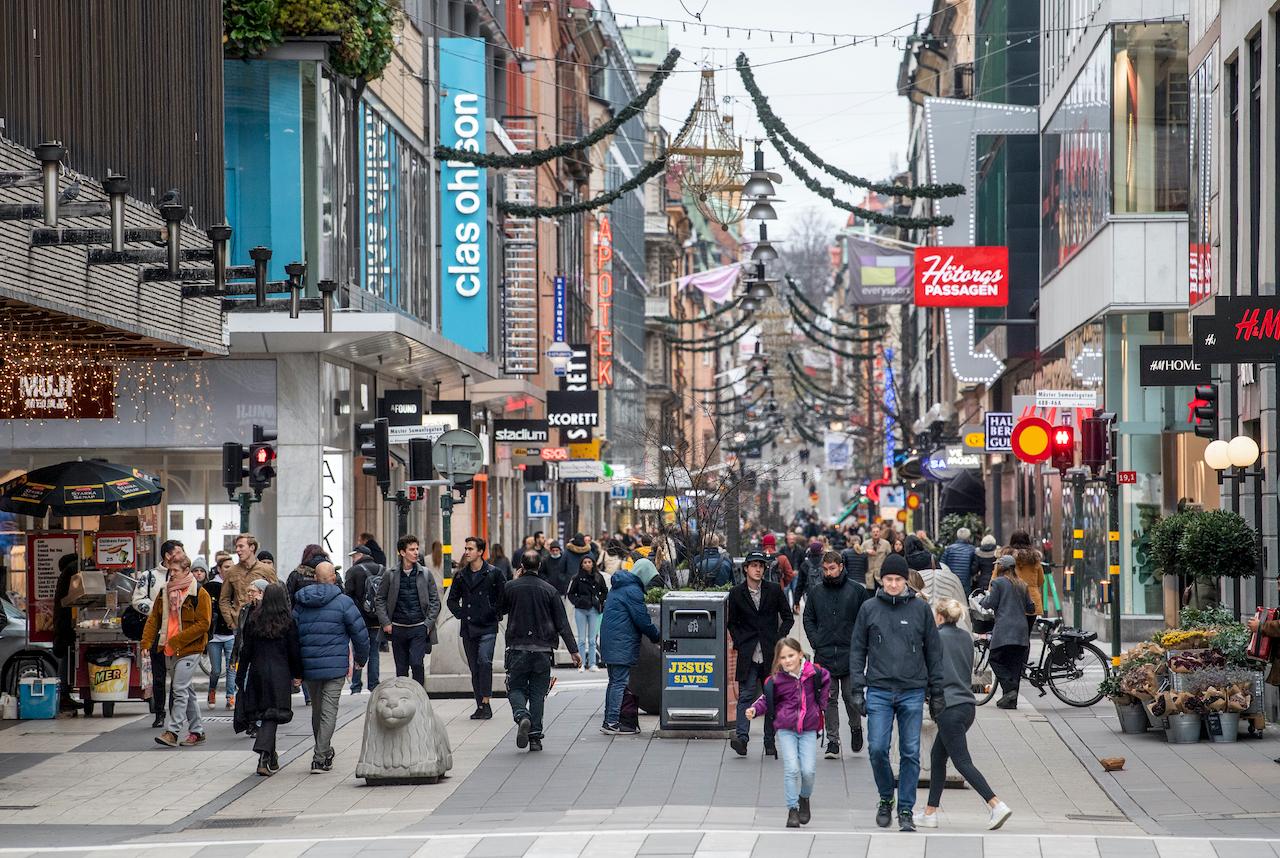 People walk along the Drottninggatan shopping street in central Stockholm, Sweden, Nov 10. Photo: AP